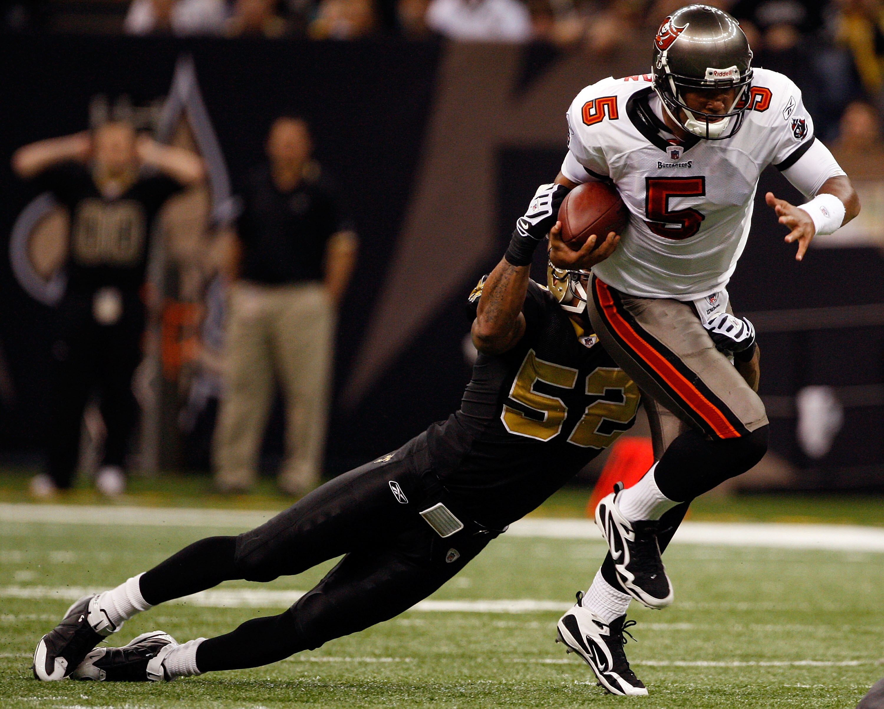NEW ORLEANS - DECEMBER 27:  Quarterback Josh Freeman #5 of the Tampa Bay Buccaneers is sacked by Jonathan Casillas #52 of the New Orleans Saints at the Louisiana Superdome on December 27, 2009 in New Orleans, Louisiana.  (Photo by Chris Graythen/Getty Ima