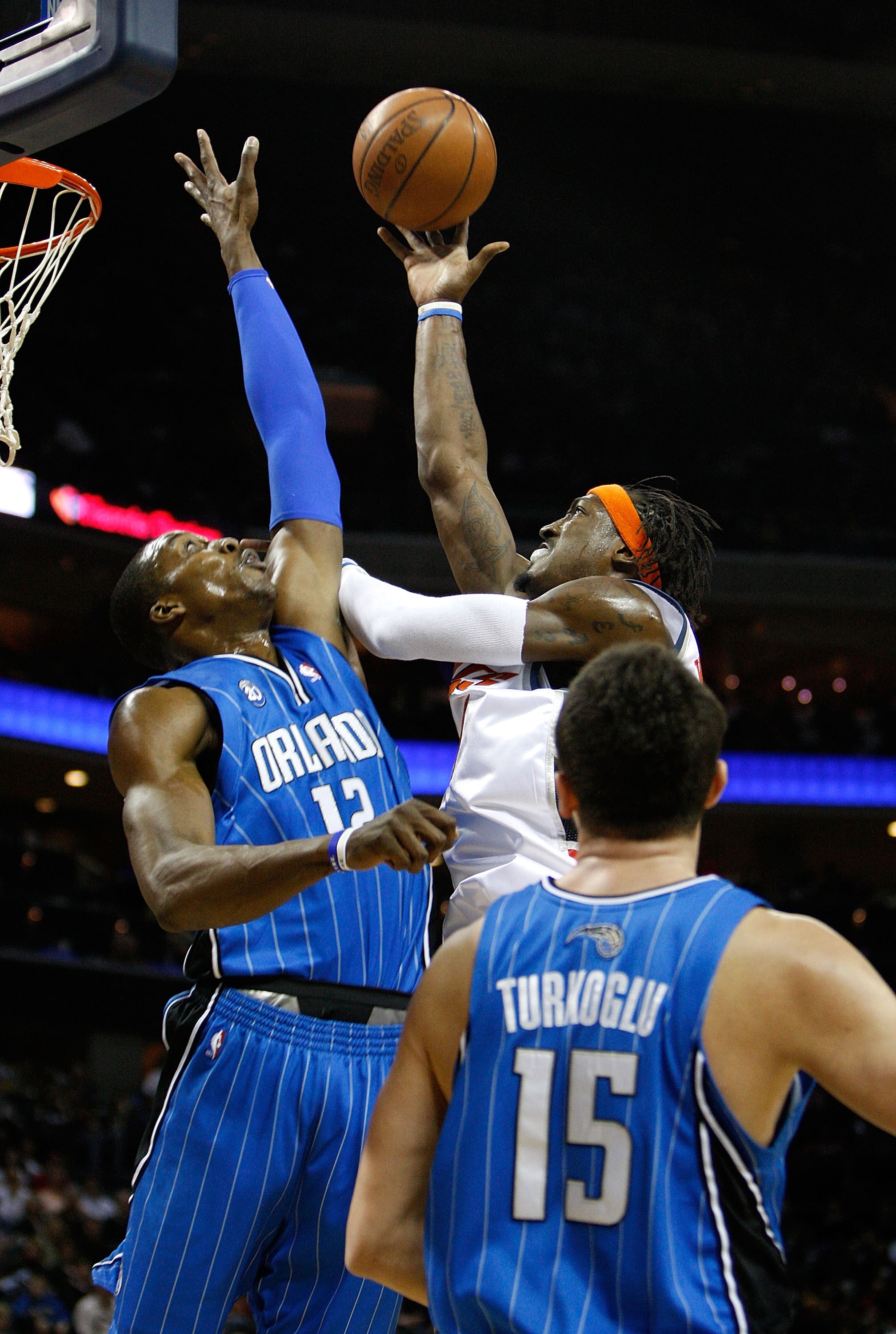 CHARLOTTE, NC - FEBRUARY 20:  Hedo Turkoglu #15 of the Orlando Magic watches on as his teammate Dwight Howard #12 tries to block the shot of Gerald Wallace #3 of the Charlotte Bobcats during their game at Time Warner Cable Arena on February 20, 2009 in Ch