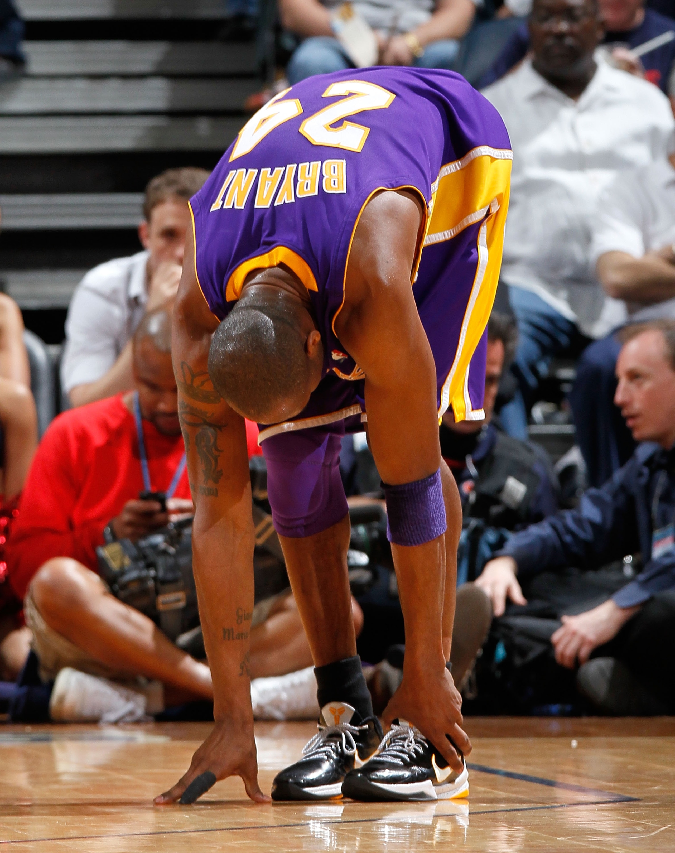 ATLANTA - MARCH 31:  Kobe Bryant #24 of the Los Angeles Lakers grabs his left ankle after attacking the basket against the Atlanta Hawks at Philips Arena on March 31, 2010 in Atlanta, Georgia.  NOTE TO USER: User expressly acknowledges and agrees that, by