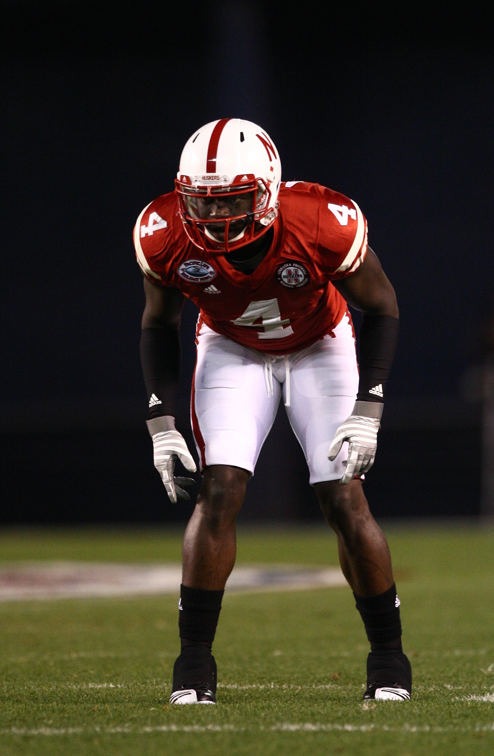 SAN DIEGO - DECEMBER 30:  Larry Asante  #4 of the University of Nebraska Cornhuskers lines up in defensive position during the Pacific Life Holiday Bowl against University of Arizona Wildcats on December 30, 2009 at Qualcomm Stadium in San Diego, Californ