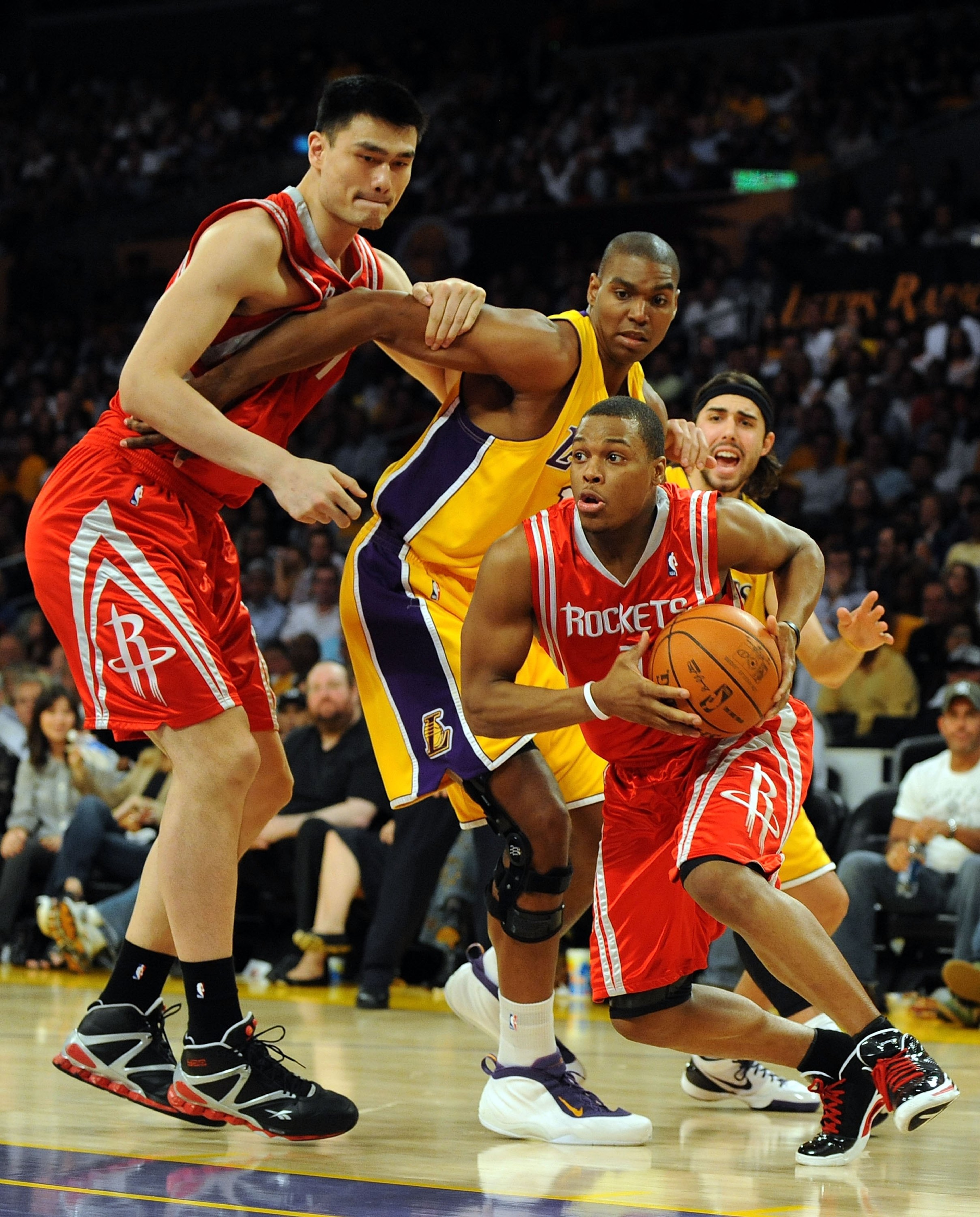 LOS ANGELES, CA - MAY 06: Kyle Lowry #7 of the Houston Rockets drives by Sasha Vujacic #18 and Andrew Bynum #17 of the Los Angeles Lakers using a screen by Yao Ming #11 of the Rockets in Game Two of the Western Conference Semifinals during the 2009 NBA P LOS ANGELES, CA - MAY 06: Kyle Lowry #7 of the Houston Rockets drives by Sasha Vujacic #18 and Andrew Bynum #17 of the Los Angeles Lakers using a screen by Yao Ming #11 of the Rockets in Game Two of the Western Conference Semifinals during the 2009 NBA P