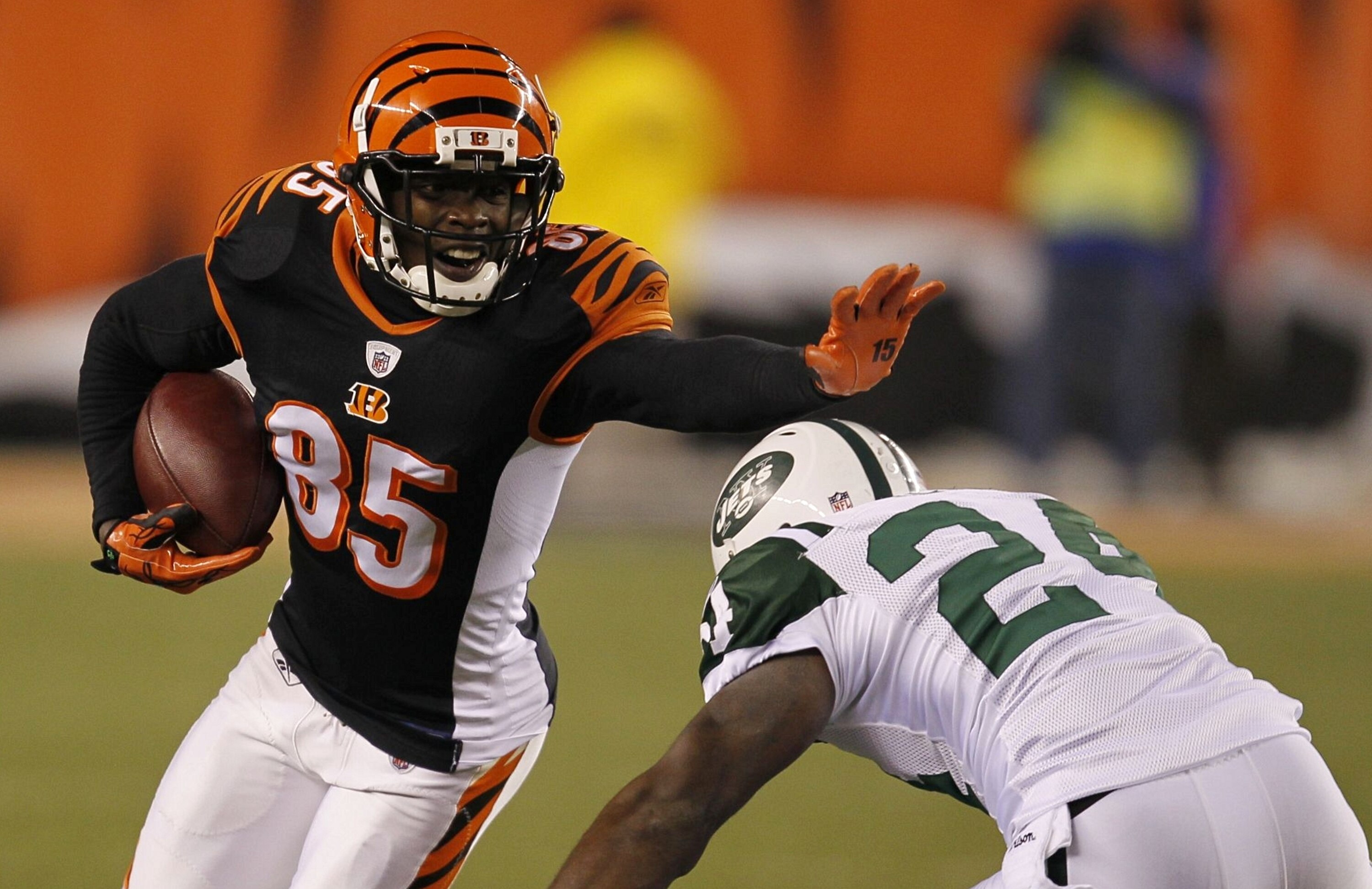 CINCINNATI - JANUARY 9:  Chad Ochocinco #85 of the Cincinnati Bengals runs after a catch before being tackled by Darrelle Revis #24 of the New York Jets in the fourth quarter during the 2010 AFC wild-card playoff game at Paul Brown Stadium on January 9, 2