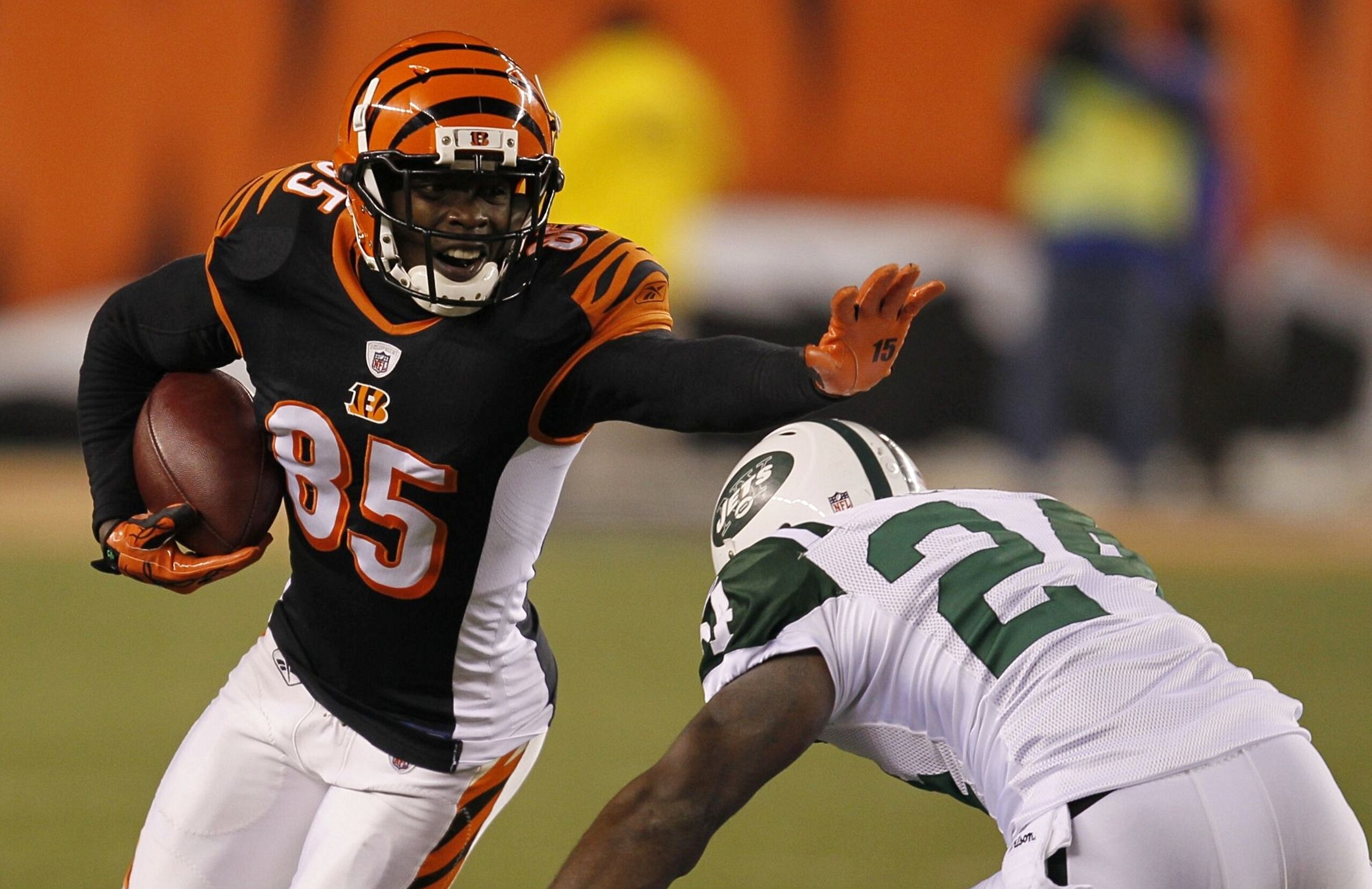 CINCINNATI - JANUARY 9: Chad Ochocinco #85 of the Cincinnati Bengals runs after a catch before being tackled by Darrelle Revis #24 of the New York Jets in the fourth quarter during the 2010 AFC wild-card playoff game at Paul Brown Stadium on January 9, 2 CINCINNATI - JANUARY 9: Chad Ochocinco #85 of the Cincinnati Bengals runs after a catch before being tackled by Darrelle Revis #24 of the New York Jets in the fourth quarter during the 2010 AFC wild-card playoff game at Paul Brown Stadium on January 9, 2