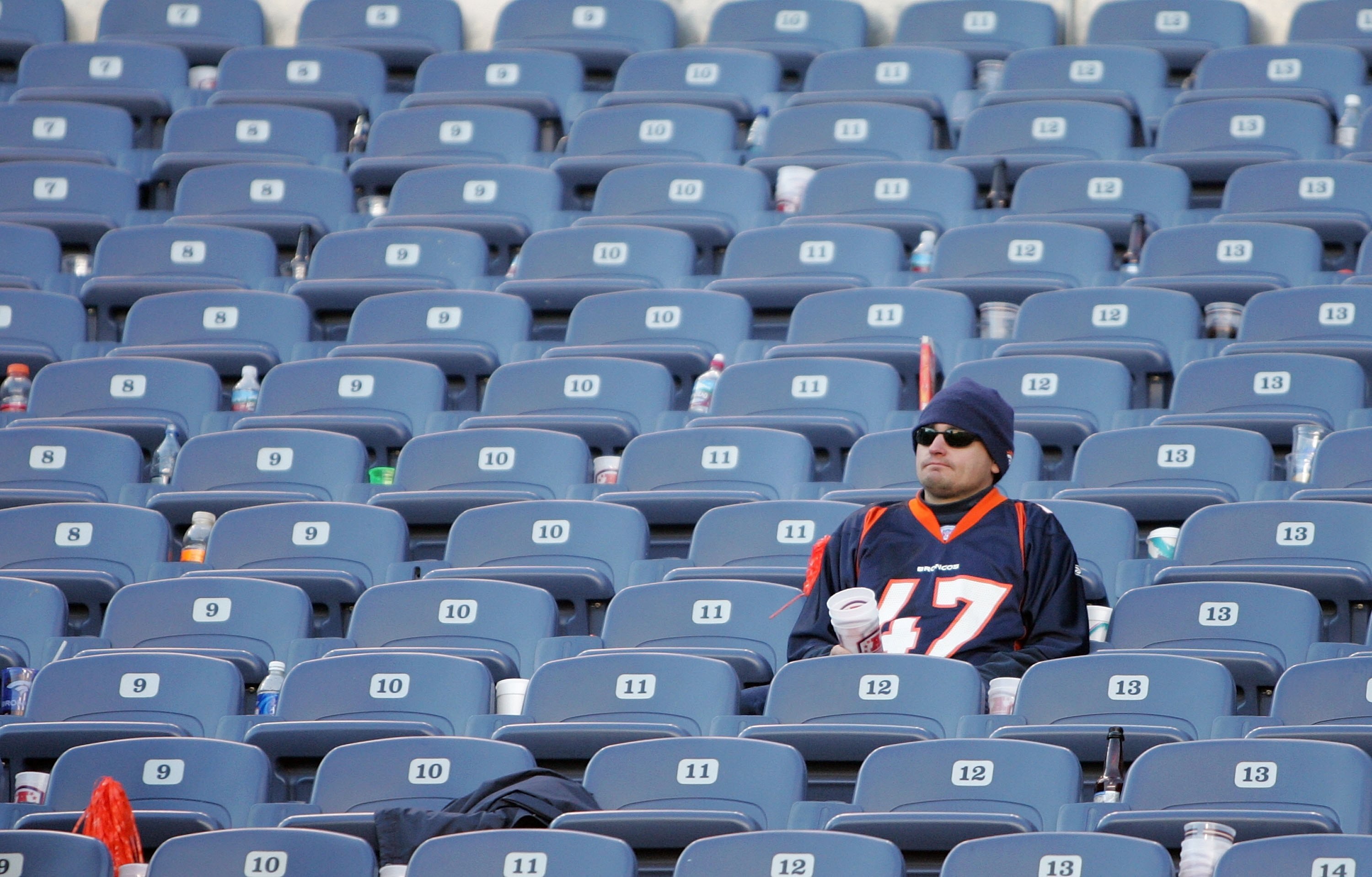 DENVER - JANUARY 22:  A lone dejected Fan of the Denver Broncos remains in the stands following the Broncos 34-17 loss against the Pittsburgh Steelers during the AFC Championship Game January 22, 2006 at Invesco Field at Mile High in Denver, Colorado.  (P