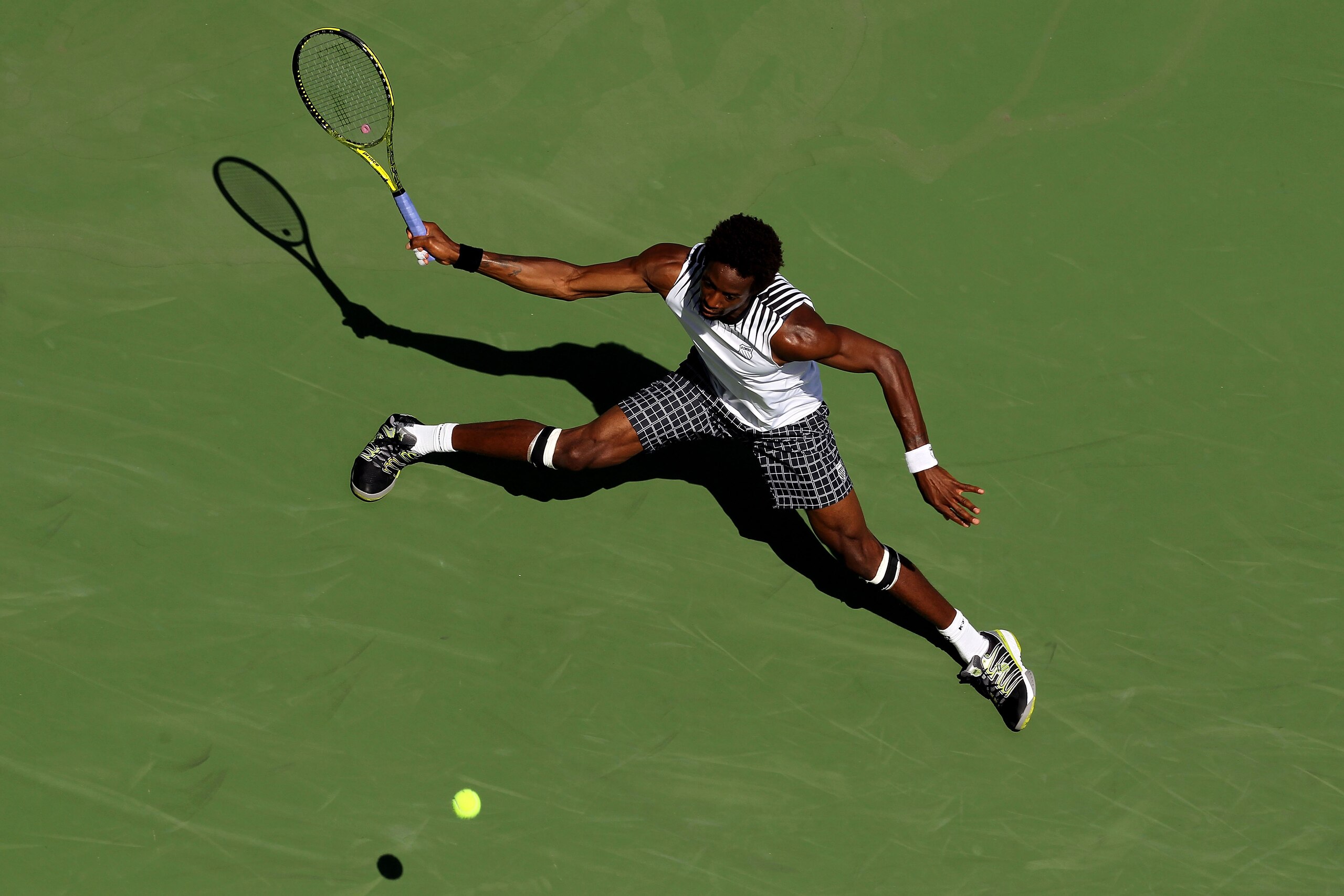 NEW YORK - SEPTEMBER 04:  Gael Monfils of France returns a shot against Janko Tipsarevic of Serbia during the men's singles match on day six of the 2010 U.S. Open at the USTA Billie Jean King National Tennis Center on September 4, 2010 in the Flushing nei