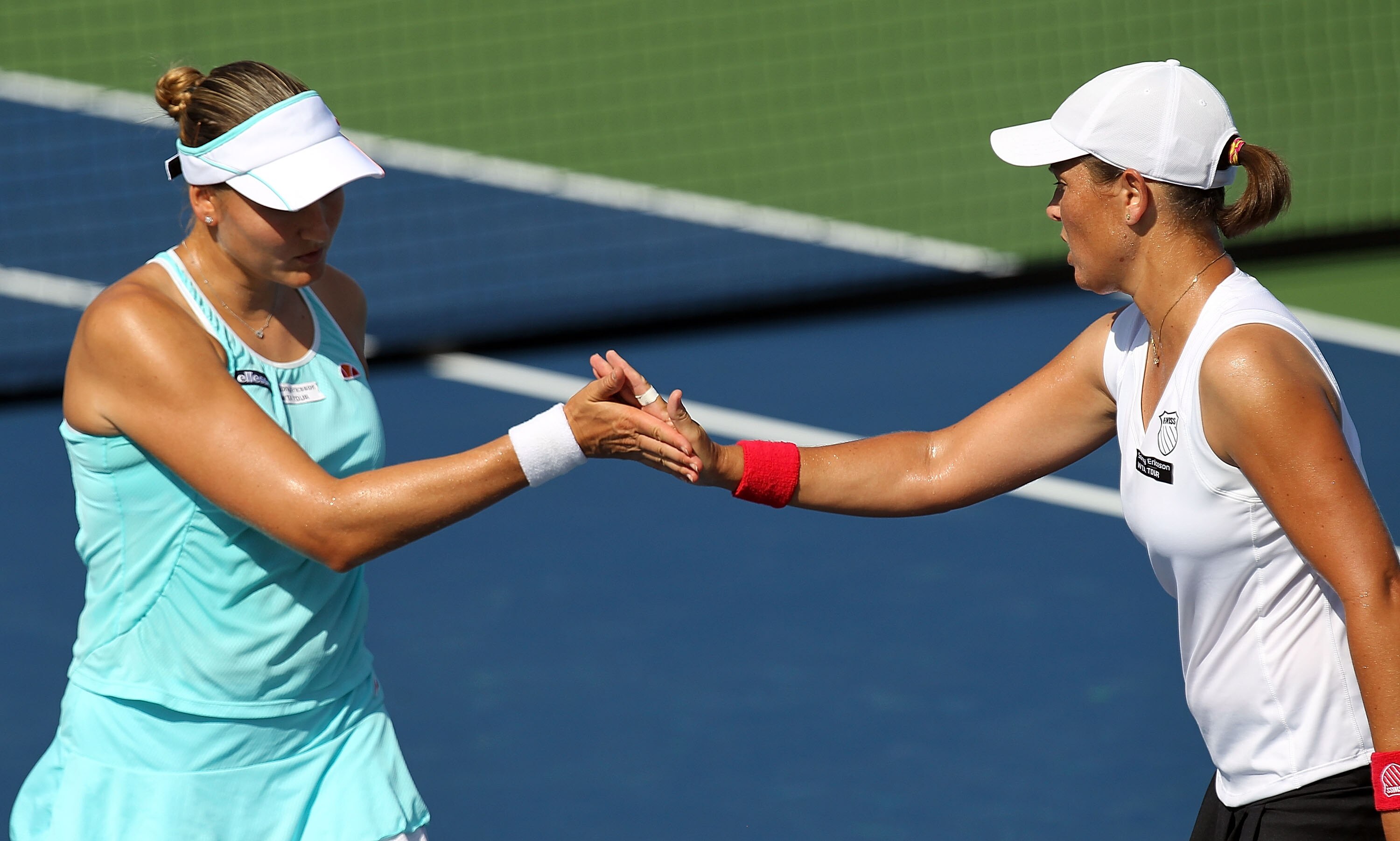 CINCINNATI - AUGUST 12:  Nadia Petrova (L) of Russia and Liezel Huber in action against Anabel Medina Garrigues of Spain and Zi Yan of China during day four of the Western & Southern Financial Group Women's Open on August 12, 2010 at the Lindner Family Te