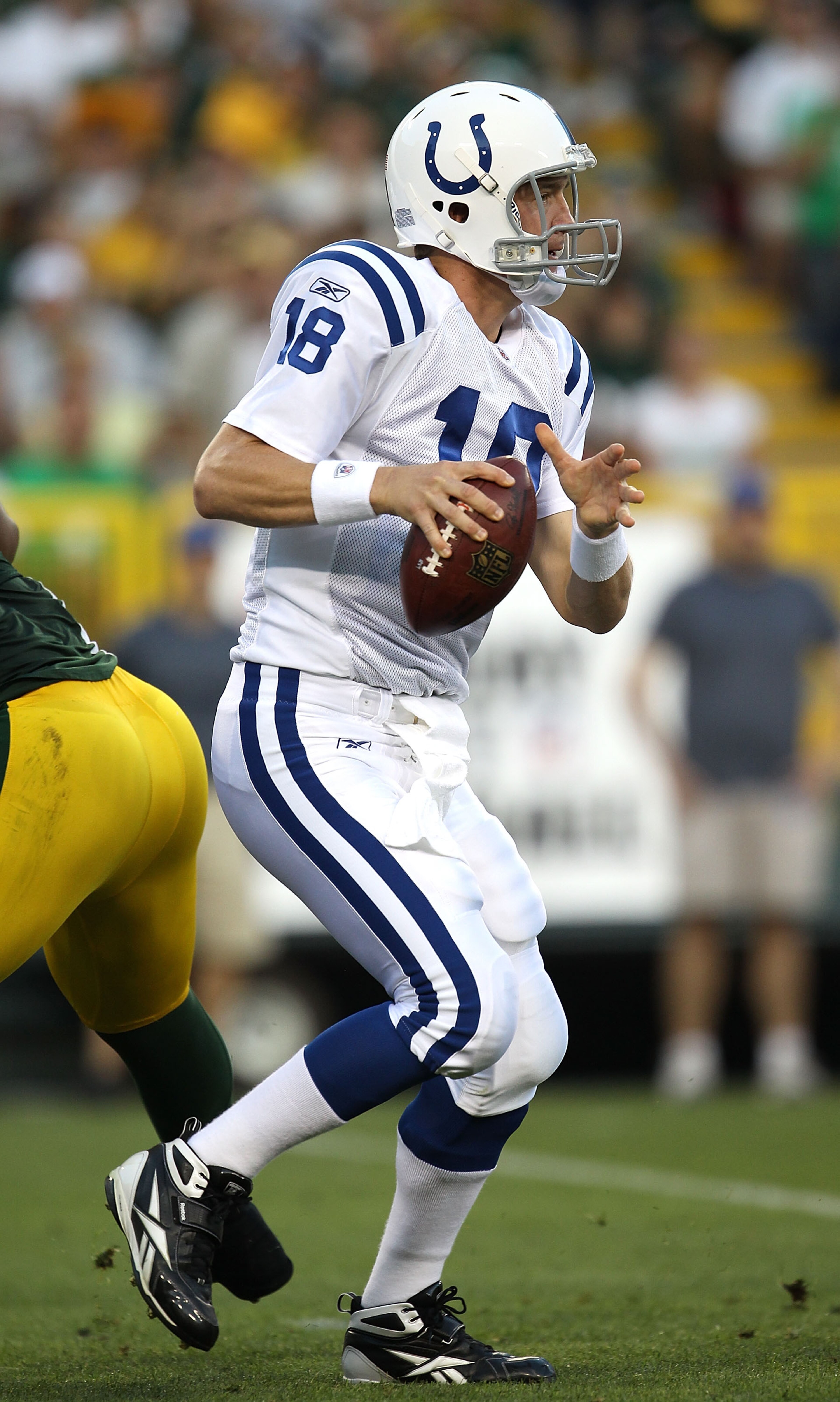 GREEN BAY, WI - AUGUST 26: Peyton Manning #18 of the Indianapolis Colts looks for a receiver against the Green Bay Packers during a preseason game at Lambeau Field on August 26, 2010 in Green Bay, Wisconsin. The Packers defeated the Colts 59-24. (Photo b GREEN BAY, WI - AUGUST 26: Peyton Manning #18 of the Indianapolis Colts looks for a receiver against the Green Bay Packers during a preseason game at Lambeau Field on August 26, 2010 in Green Bay, Wisconsin. The Packers defeated the Colts 59-24. (Photo b