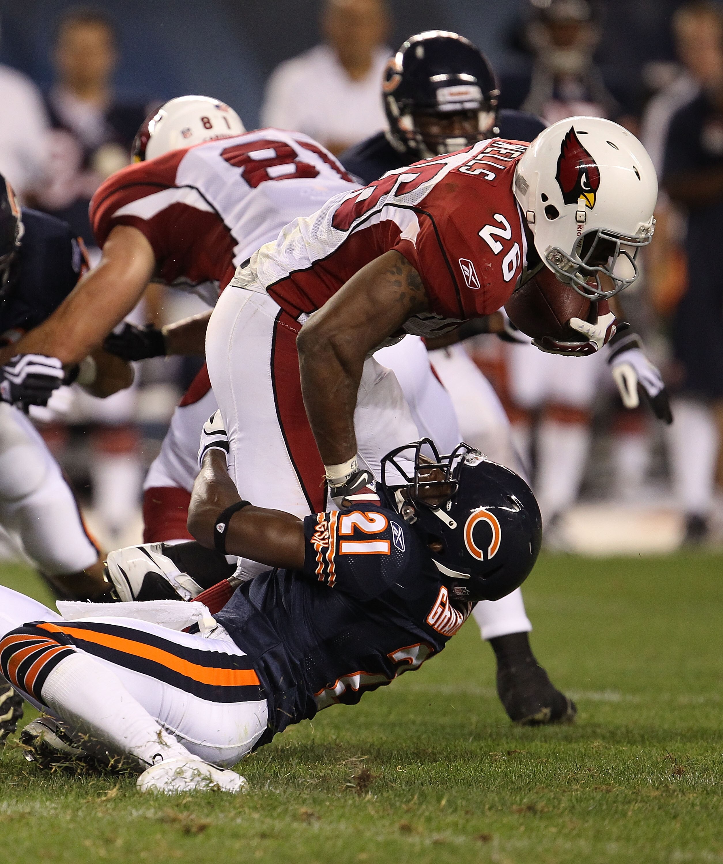 CHICAGO - AUGUST 28: Corey Graham #21 of the Chicago Bears drops Beanie Wells #26 of the Arizona Cardinals during a preseason game at Soldier Field on August 28, 2010 in Chicago, Illinois. The Cardinals defeated the Bears 14-9. (Photo by Jonathan Daniel/G
