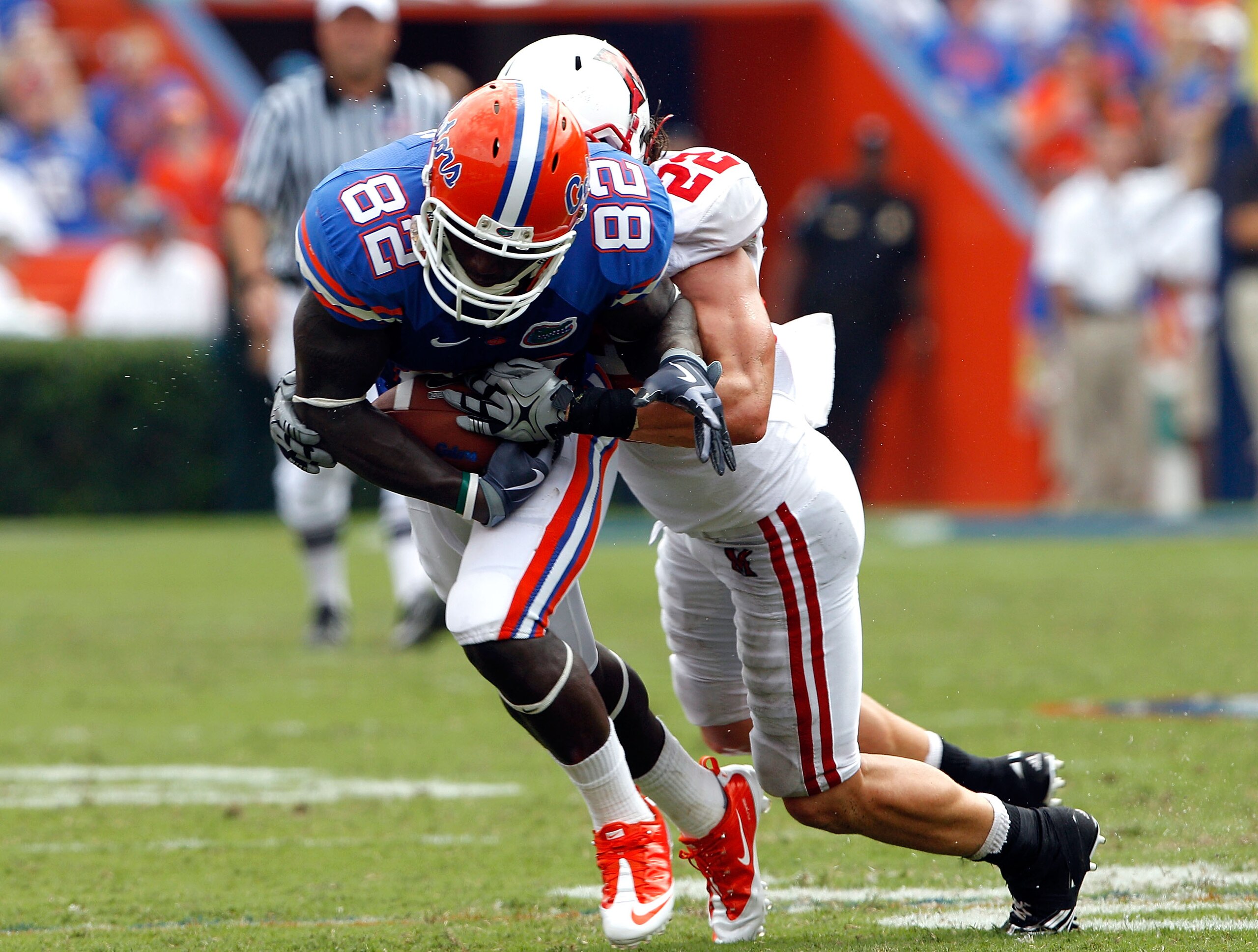 GAINESVILLE, FL - SEPTEMBER 04:  Omarius Hines #82 of the Florida Gators is tackled by Jordan Gafford #22 of the Miami University RedHawks at Ben Hill Griffin Stadium on September 4, 2010 in Gainesville, Florida.  (Photo by Sam Greenwood/Getty Images)