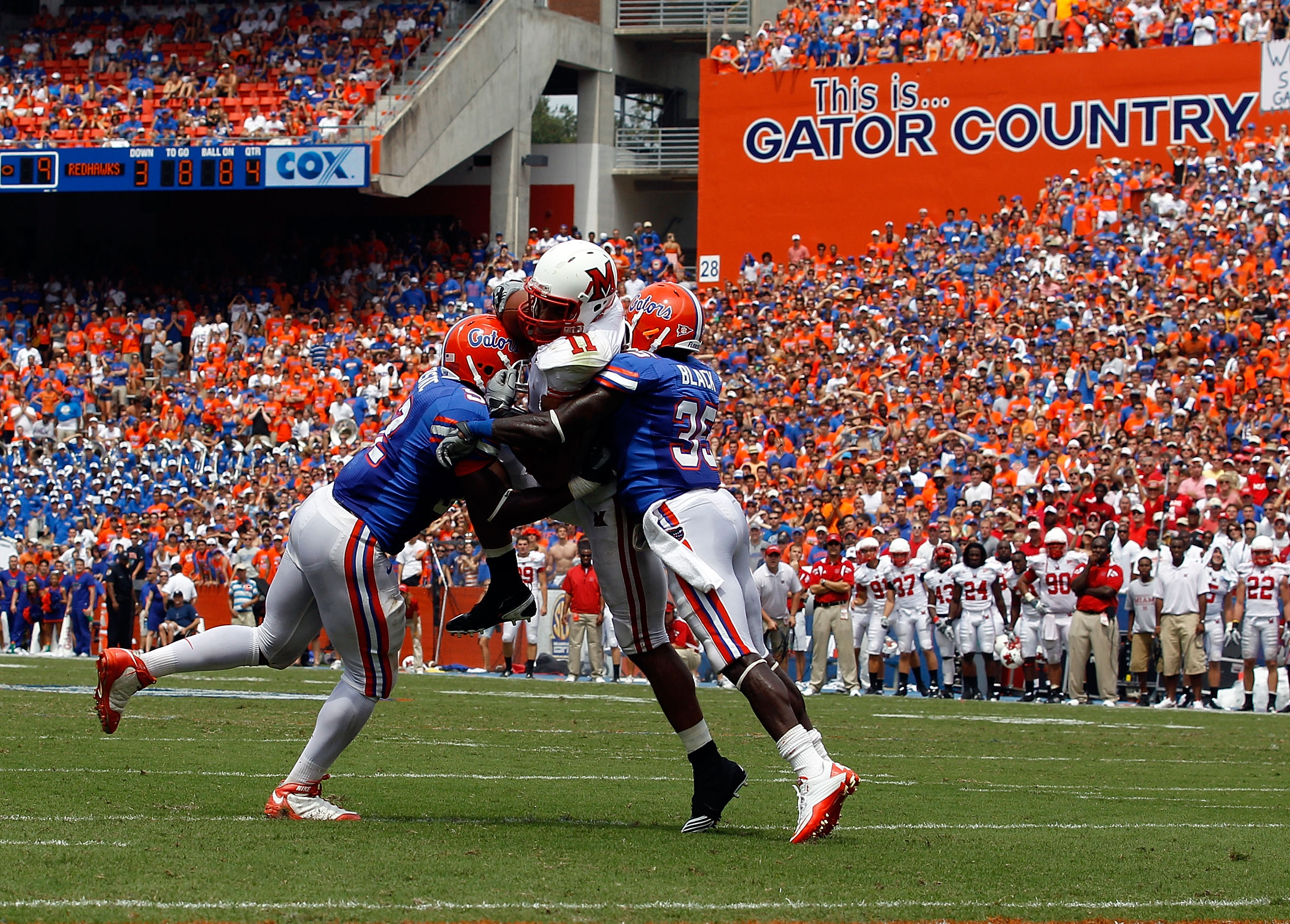 GAINESVILLE, FL - SEPTEMBER 04: Jonathan Bostic #52 of the Florida Gators and Ahmad Black #35 tackle Armand Robinson #11 of the Miami University RedHawks at Ben Hill Griffin Stadium on September 4, 2010 in Gainesville, Florida. (Photo by Sam Greenwood/Ge GAINESVILLE, FL - SEPTEMBER 04: Jonathan Bostic #52 of the Florida Gators and Ahmad Black #35 tackle Armand Robinson #11 of the Miami University RedHawks at Ben Hill Griffin Stadium on September 4, 2010 in Gainesville, Florida. (Photo by Sam Greenwood/Ge