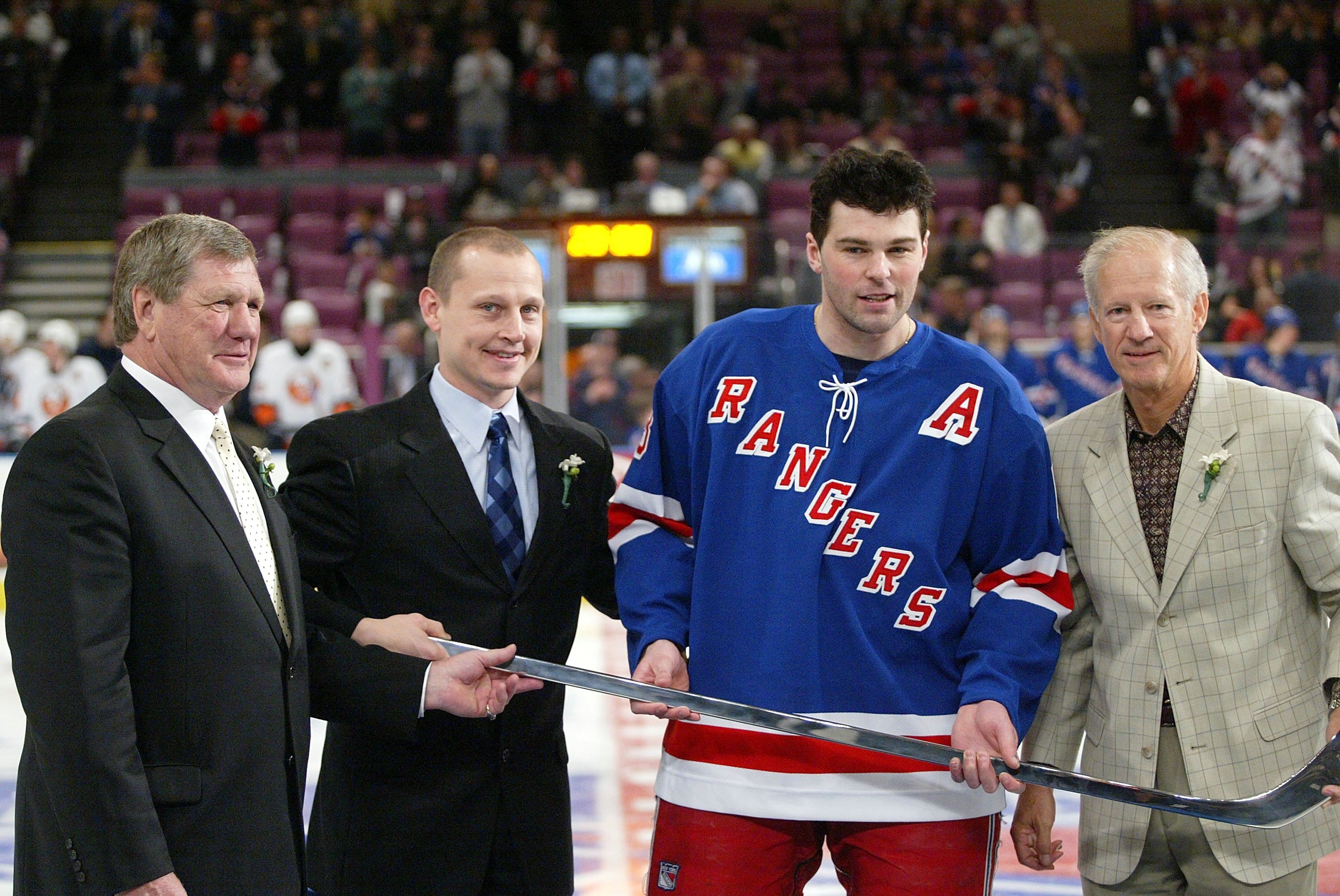 NEW YORK - APRIL 11:  Jaromir Jagr #68 of the New York Rangers is awarded a silver stick by Vic Hatfield (L) Adam Graves and Jean Ratelle (R) prior to the game against the New York Islanders on April 11, 2006 at Madison Square Garden in New York City.  (P