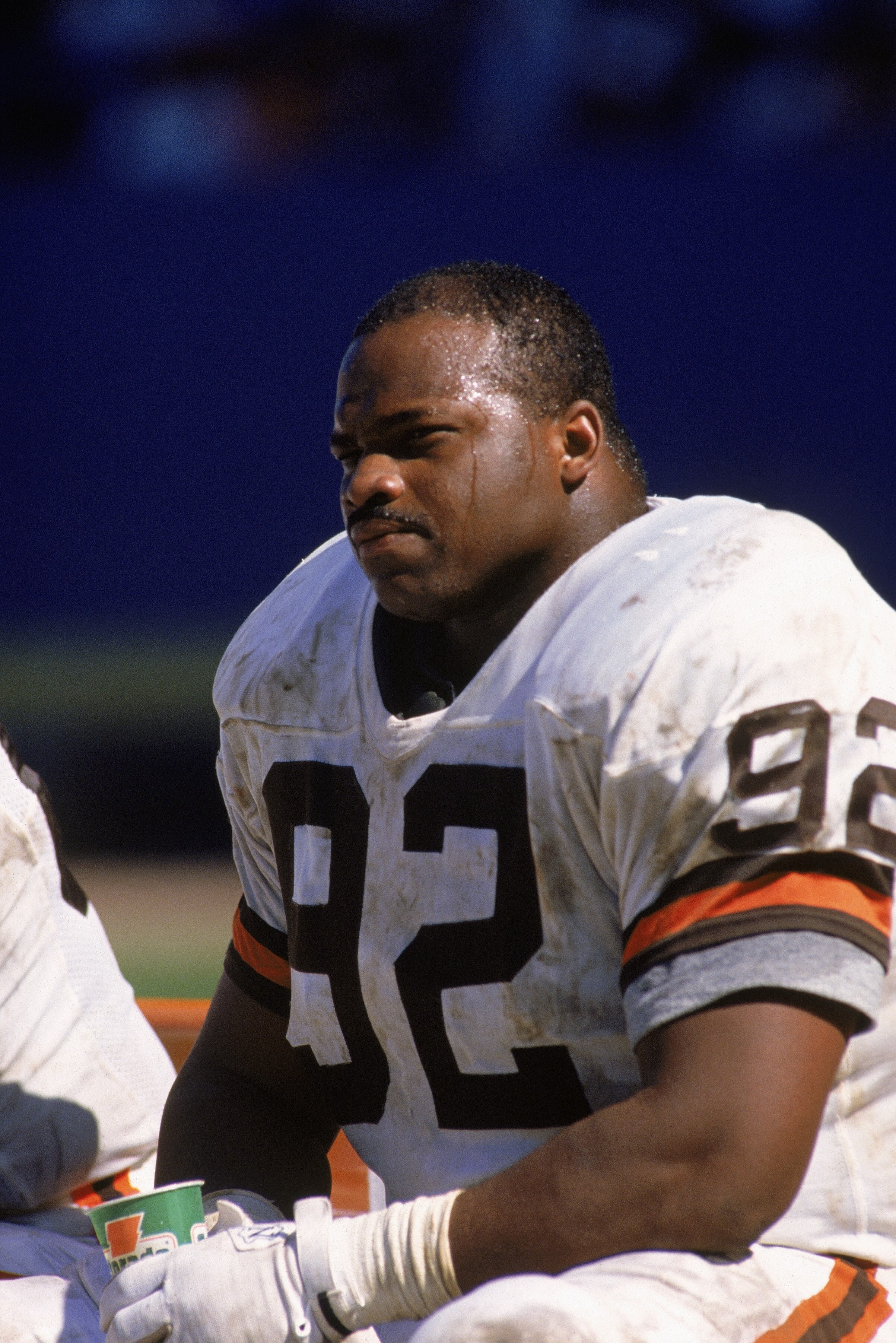 1990:  Defensive tackle Michael Dean Perry #92 of the Cleveland Browns sits on the sideline during a 1990 NFL game against the New York Jets.  The Browns defeated the Jets 38-24. (Photo by Rick Stewart/Getty Images)