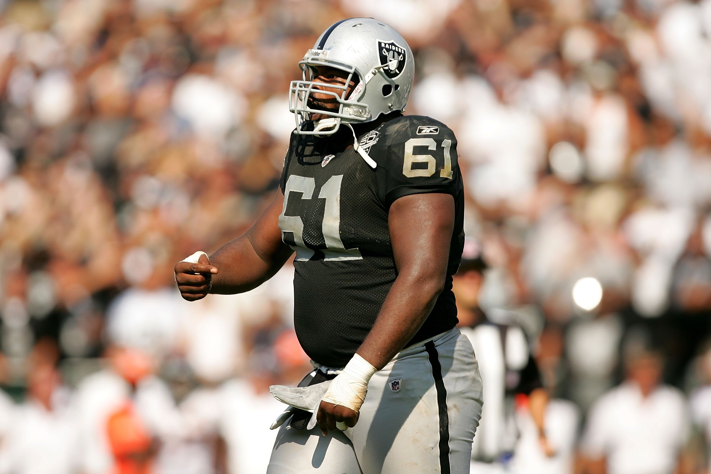 OAKLAND, CA - SEPTEMBER 27:  Gerard Warren #61 of the Oakland Raiders reacts after a play during their game against the Denver Broncos at the Oakland-Alameda County Coliseum on September 27, 2009 in Oakland, California.  (Photo by Ezra Shaw/Getty Images)