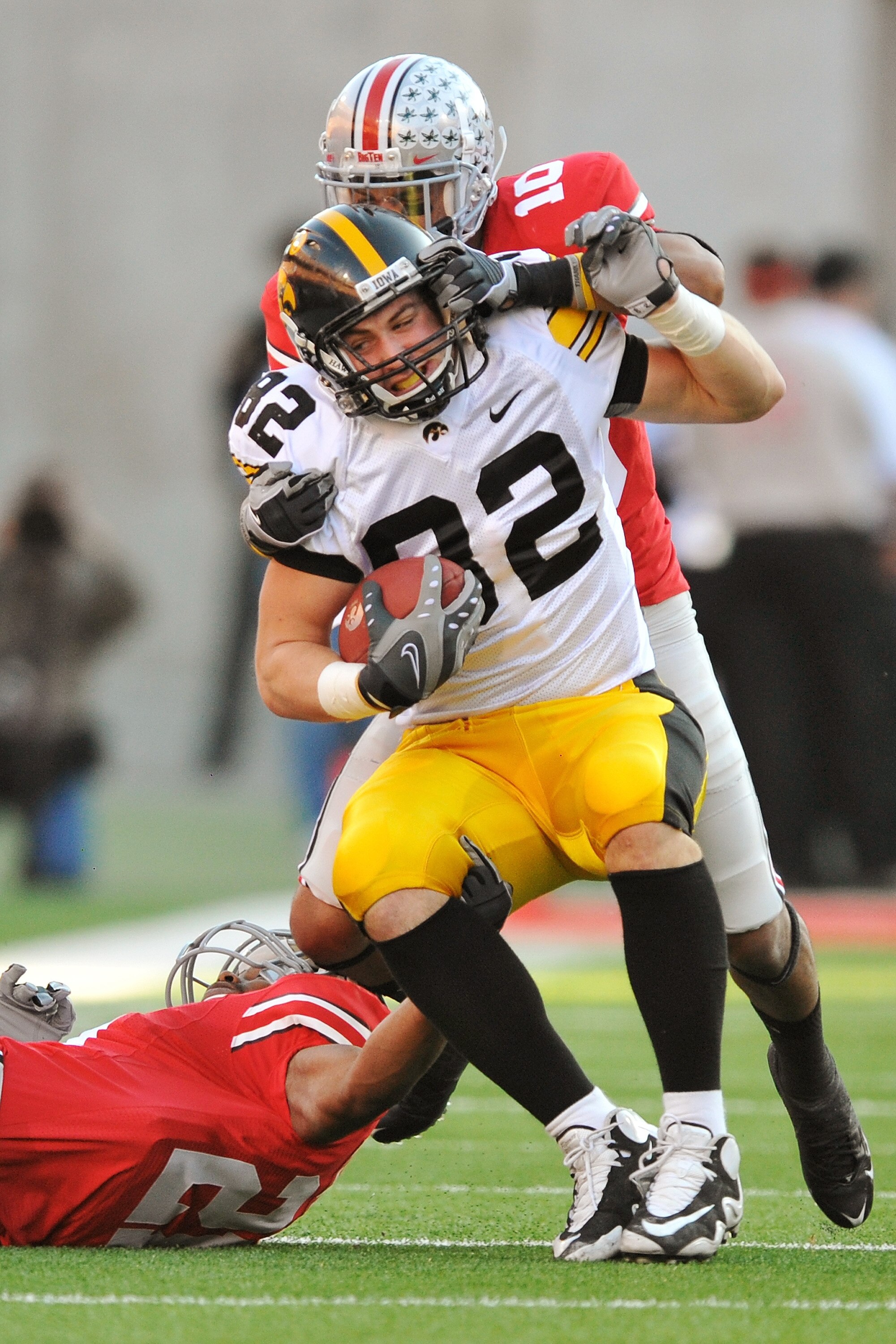 COLUMBUS, OH - NOVEMBER 14:  Tight end Allen Reisner #82 of the Iowa Hawkeyes is tackled by Devon Torrence #10 of the Ohio State Buckeyes after a reception at Ohio Stadium on November 14, 2009 in Columbus, Ohio.  (Photo by Jamie Sabau/Getty Images)