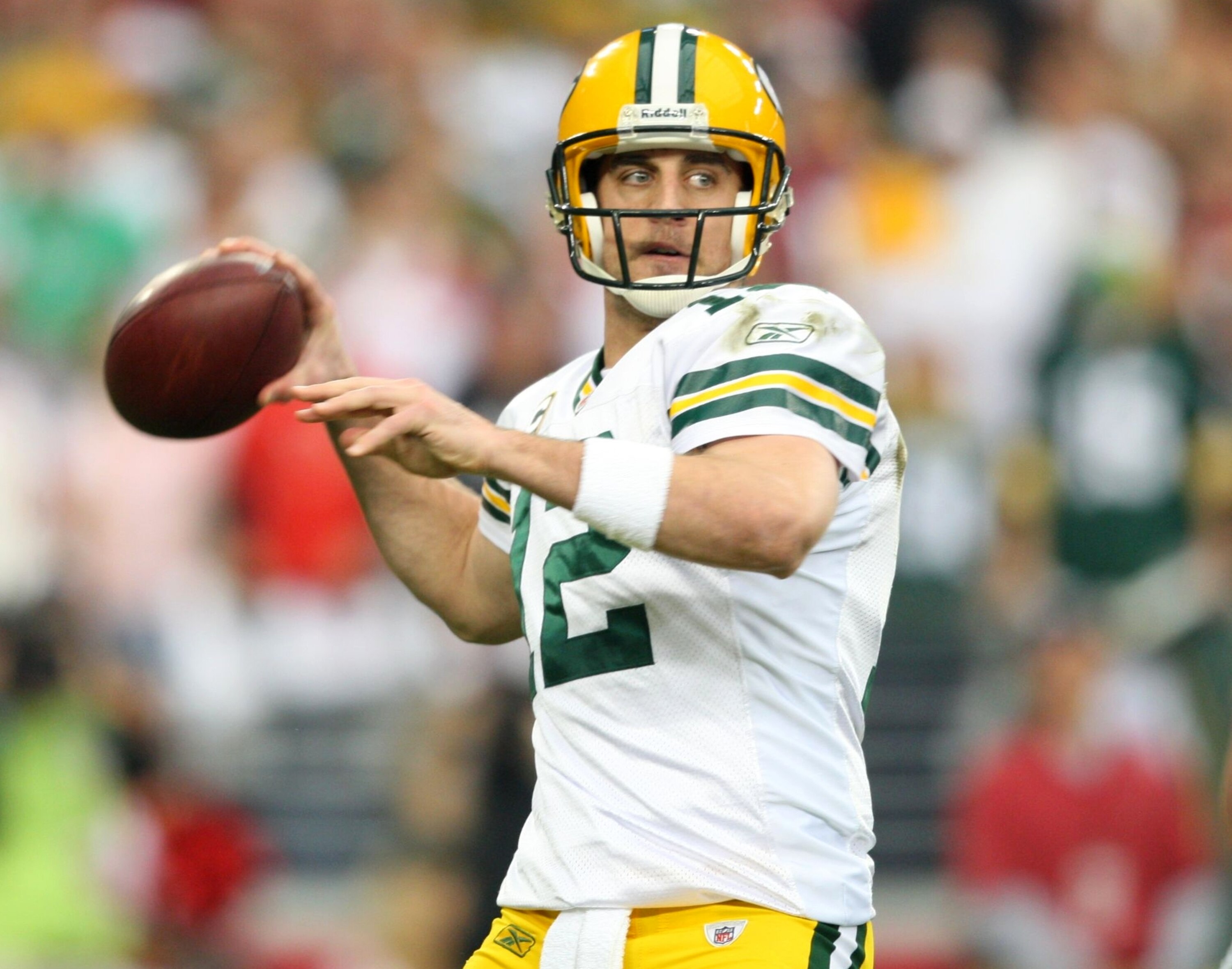 GLENDALE, AZ - JANUARY 10:  Quarterback Aaron Rodgers #12 of the Green Bay Packers throws the ball against the Arizona Cardinals during the first quarter of the 2010 NFC wild-card playoff game at University of Phoenix Stadium on January 10, 2010 in Glenda