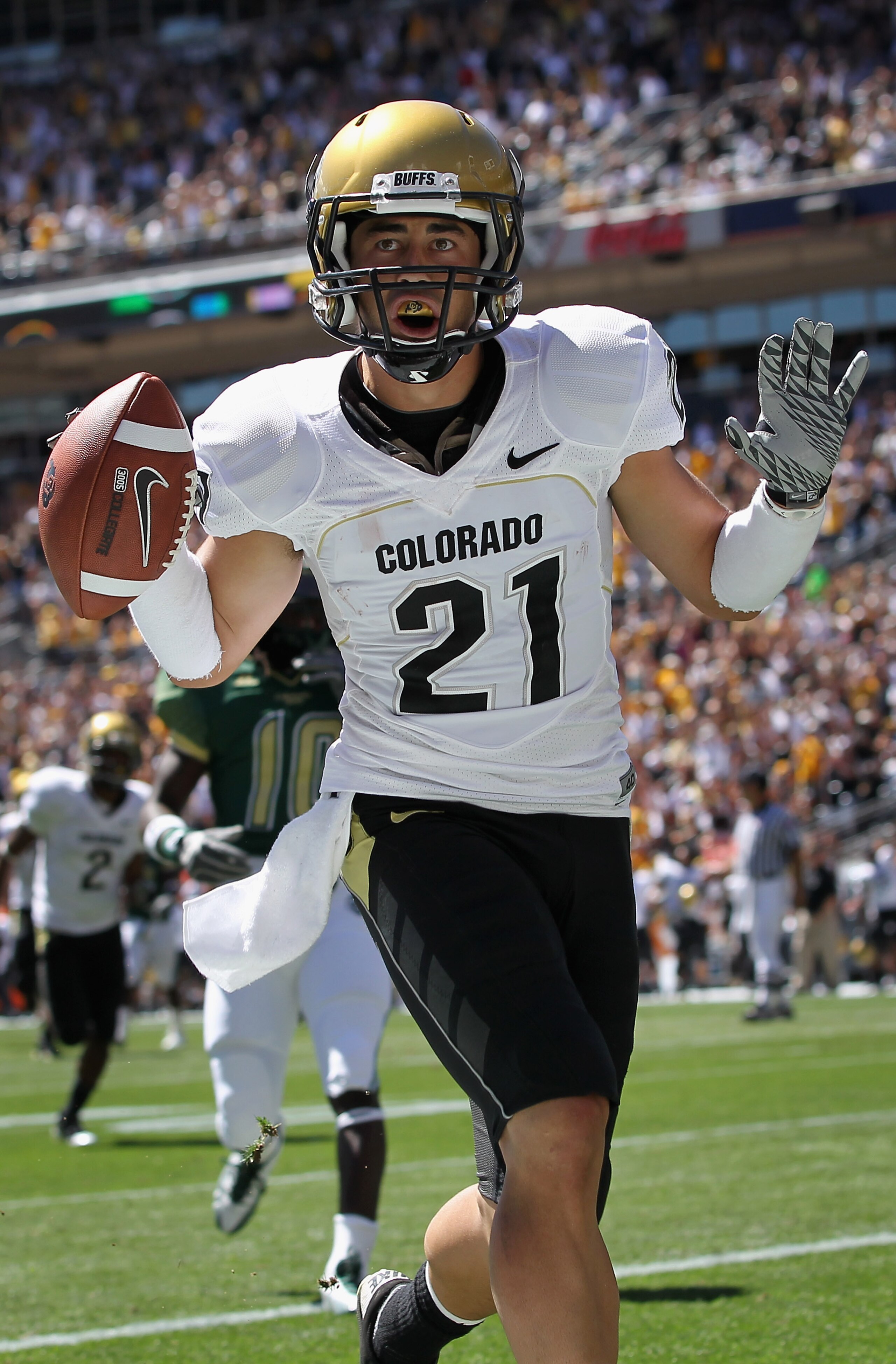 DENVER - SEPTEMBER 04:  Wide receiver Scotty McKnight #21 of the Colorado Buffaloes celebrates 27 yard touchdown reception to give the Buffs a 14-0 lead over the Colorado State Rams in the second quarter of the Rocky Mountain Showdown at INVESCO Field at