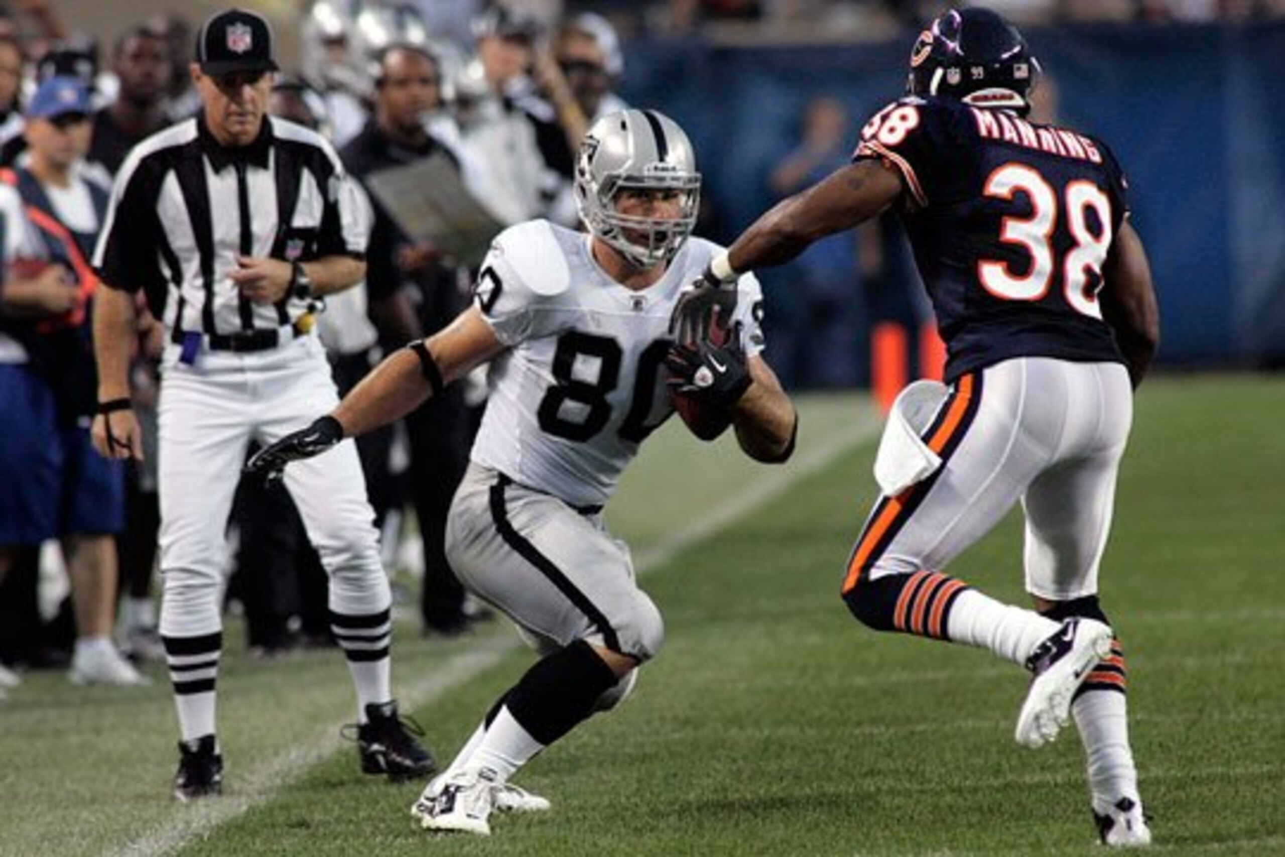 Miller makes a move on Daniel Manning of the bears.