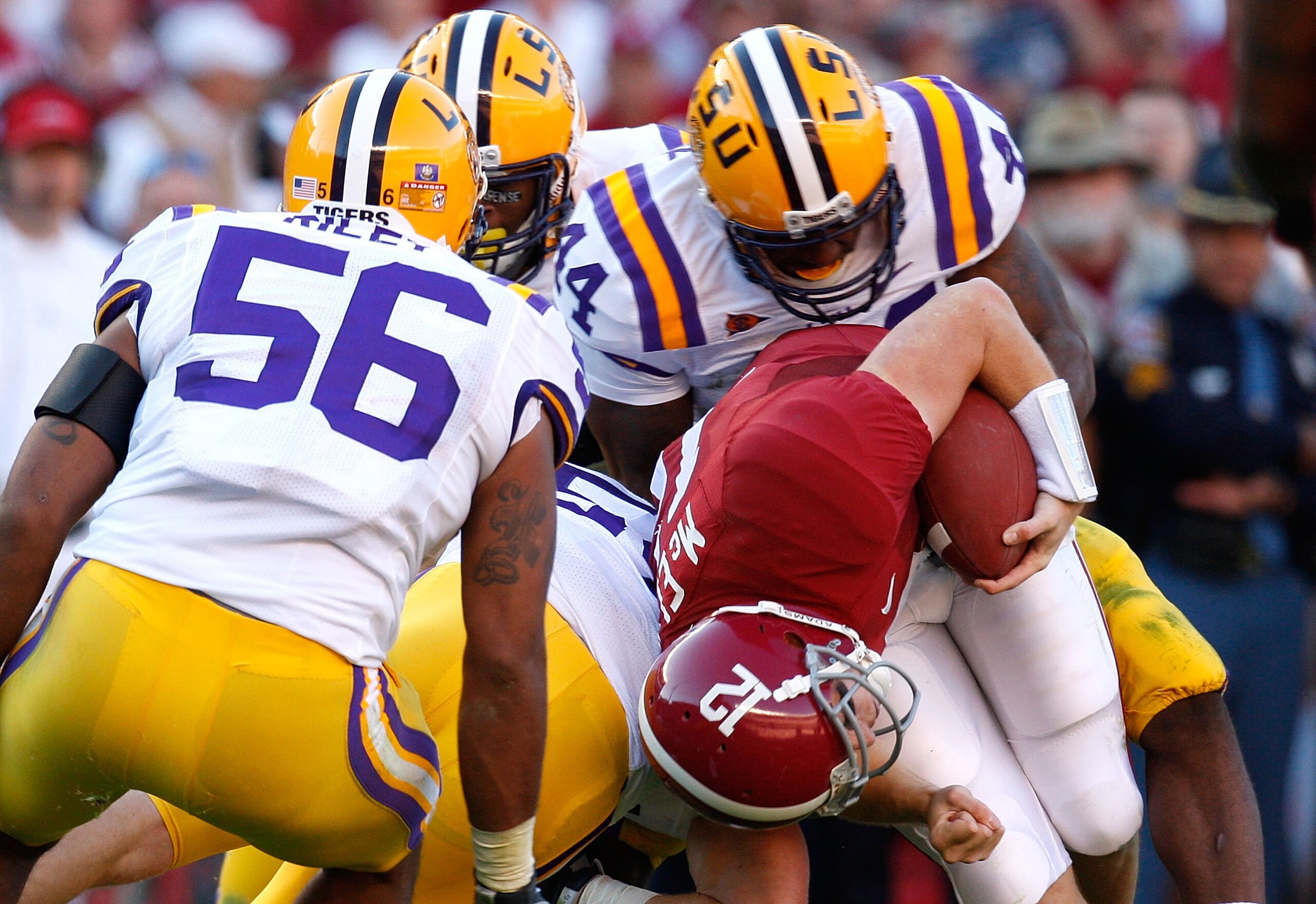 TUSCALOOSA, AL - NOVEMBER 07:  Perry Riley #56 and Danny McCray #44 of the Louisiana State University Tigers tackle quarterback Greg McElroy #12 of the Alabama Crimson Tide at Bryant-Denny Stadium on November 7, 2009 in Tuscaloosa, Alabama.  (Photo by Kev