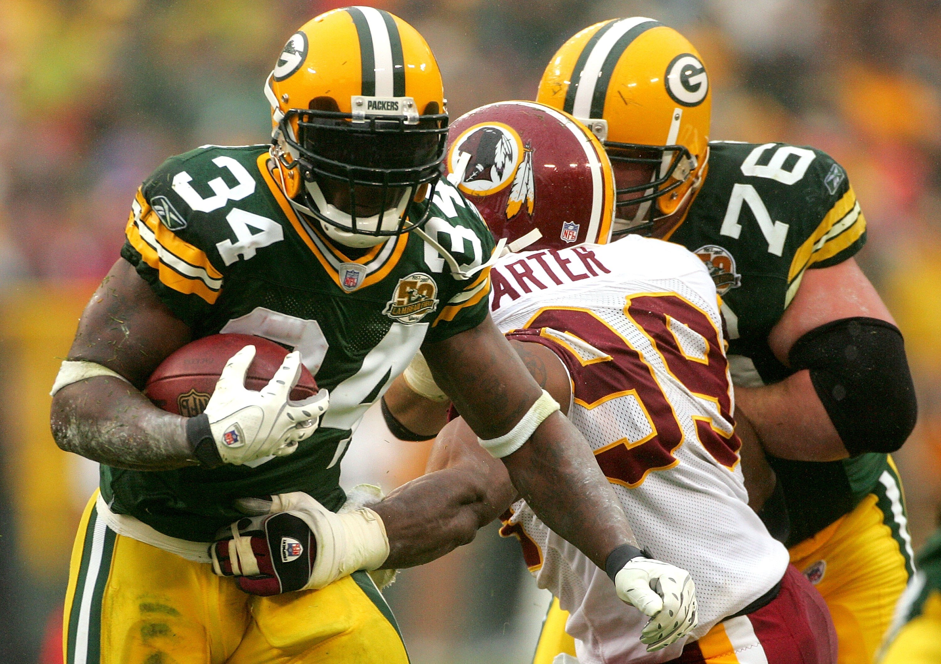 GREEN BAY, WI - OCTOBER 14:  Vernand Morency #34 of the Green Bay Packers tries to break free from Andre Carter #99 of the Washington Redskins October 14, 2007 at Lambeau Field in Green Bay, Wisconsin.  (Photo by Matthew Stockman/Getty Images)