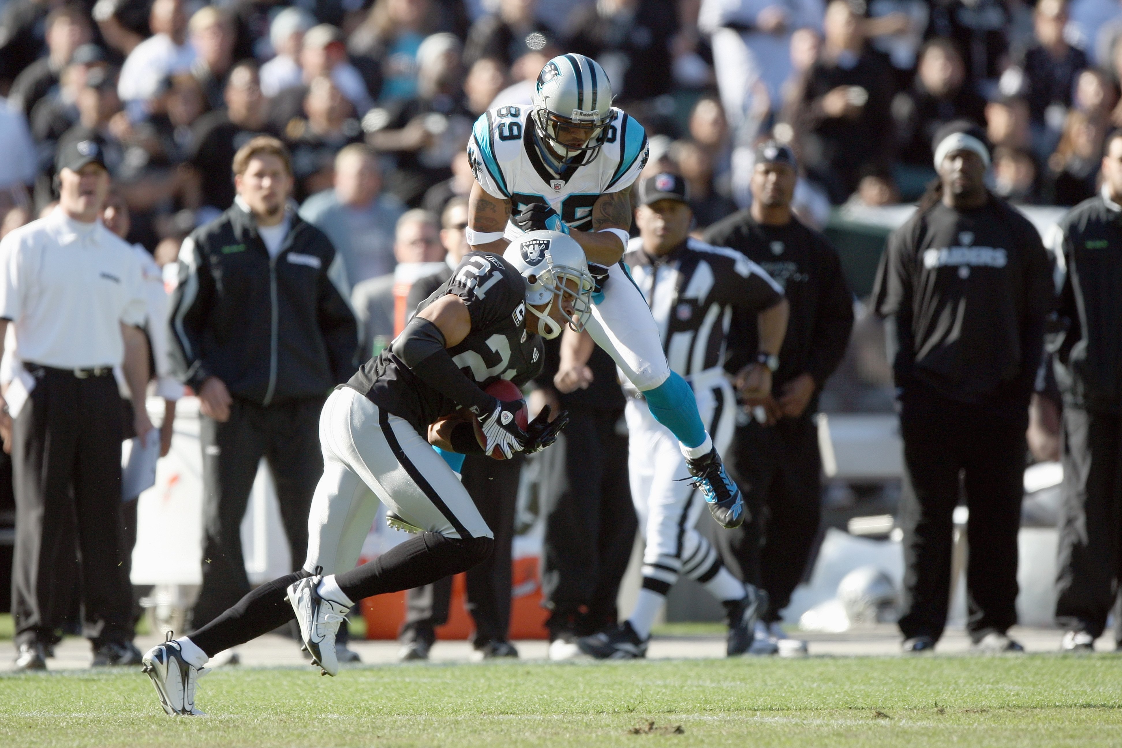 OAKLAND - NOVEMBER 9:  Steve Smith #89 of the Carolina Panthers collides with Nnamdi Asomugha #21of the Oakland Raiders at the Oakland-Alameda County Coliseum on November 9, 2008 in Oakland, California. (Photo by: Jed Jacobsohn/Getty Images)