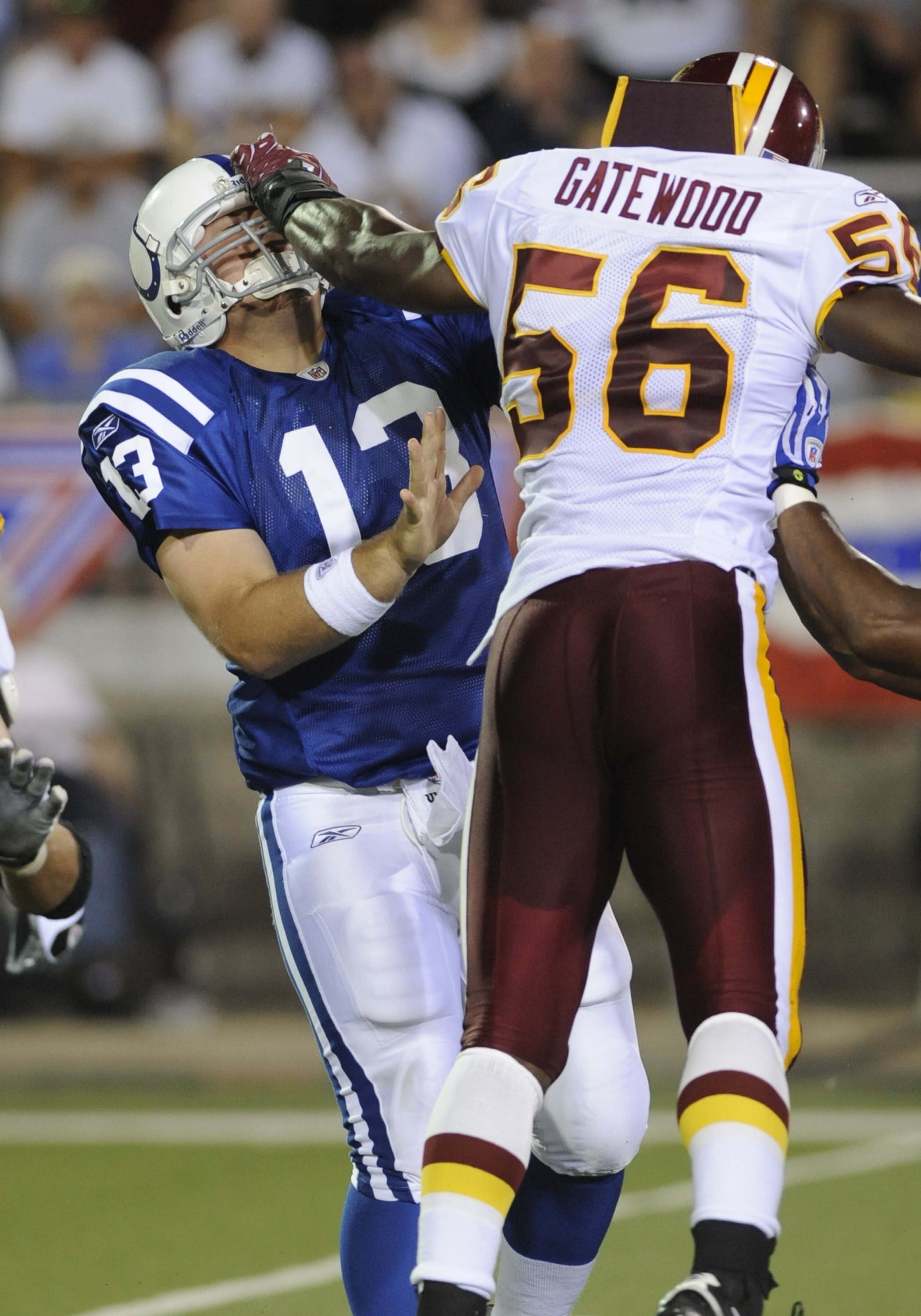 CANTON, OH - AUGUST 3: Quarterback Jared Lorenzen #13 of the Indianapolis Colts is hit by linebacker Curtis Gatewood #56 of the Washington Redskins in the Pro Football Hall of Fame Game at Fawcett Stadium on August 3, 2008 in Canton, Ohio.   (Photo by Al 