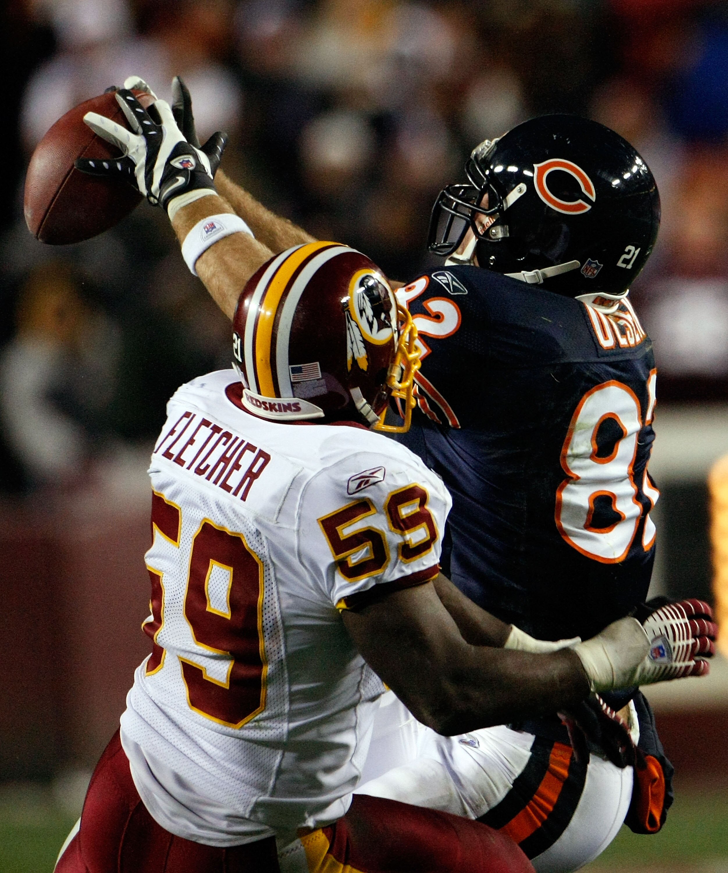 LANDOVER, MD - DECEMBER 06:  Tight end Greg Olsen #82 of the Chicago Bears makes a catch against linebacker London Fletcher #59 of the Washington Redskins in third quarter action at FedEx Field December 6, 2007 in Landover, Maryland. The Redskins won the 