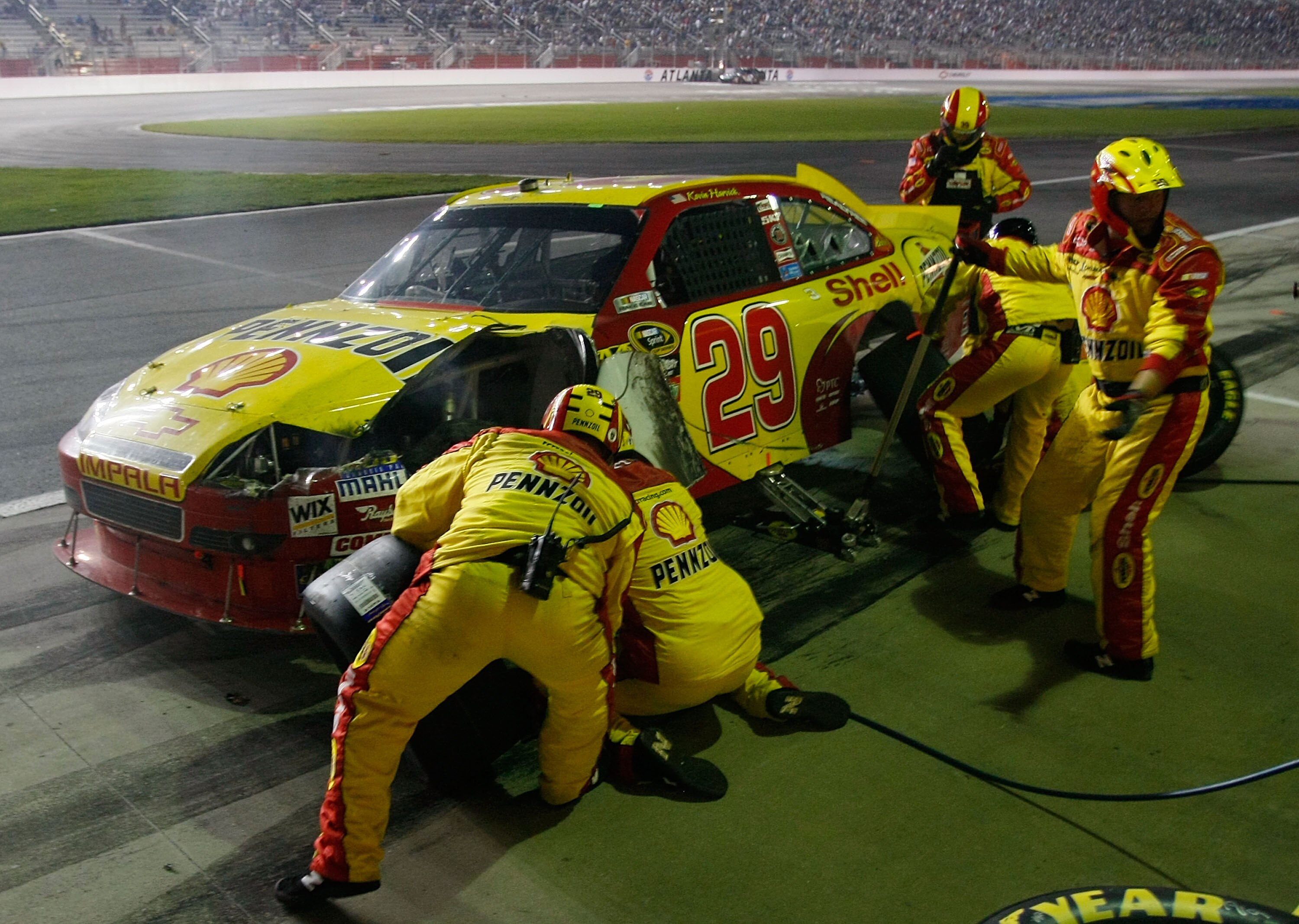 HAMPTON, GA - SEPTEMBER 05:  Kevin Harvick, driver of the #29 Shell/Pennzoil Chevrolet, pits as his crew repairs damage to the car during the NASCAR Sprint Cup Series Emory Healthcare 500 at Atlanta Motor Speedway on September 5, 2010 in Hampton, Georgia.