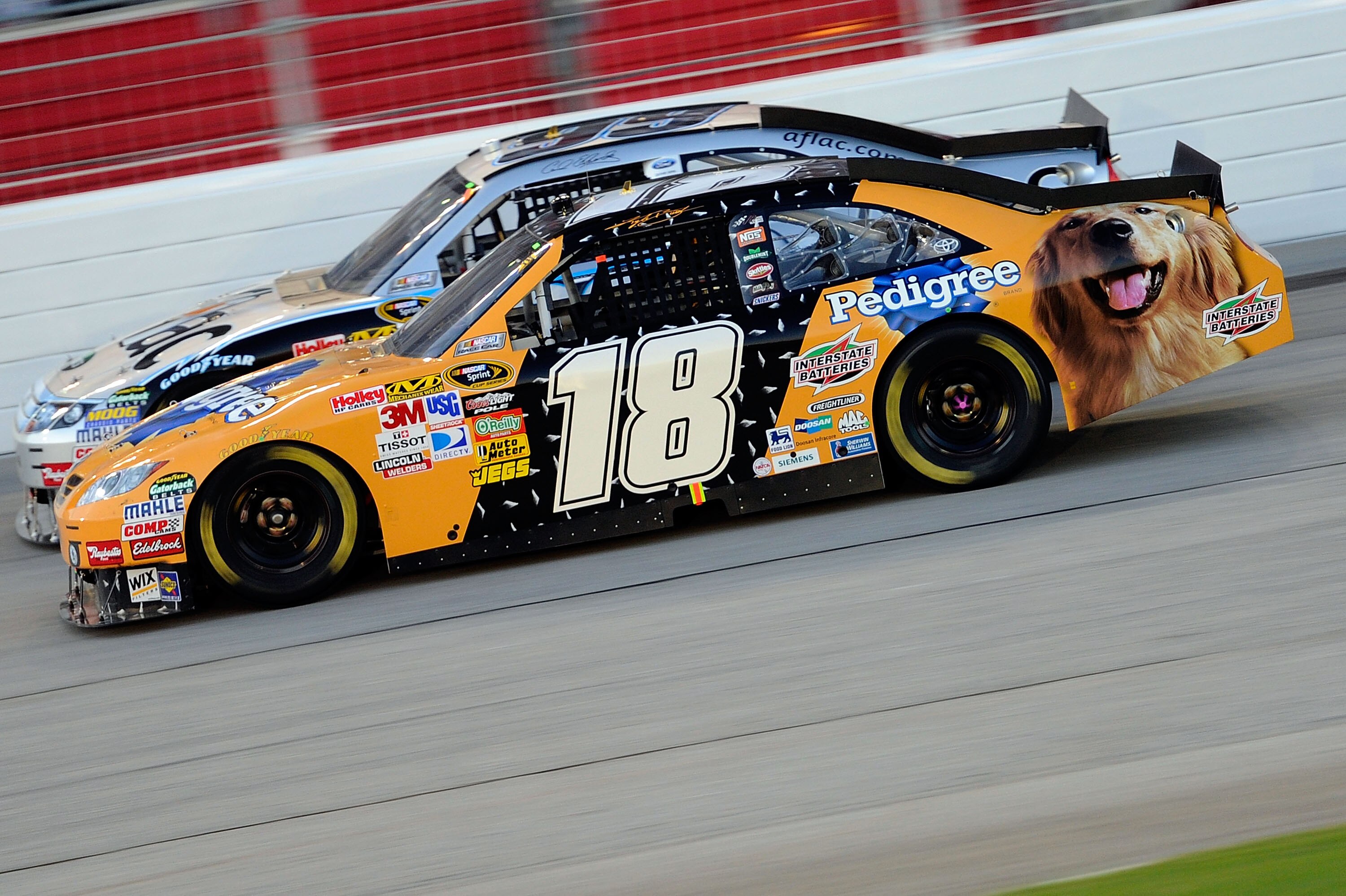 HAMPTON, GA - SEPTEMBER 05:  Kyle Busch, driver of the #18 Pedigree Toyota, races Carl Edwards, driver of the #99 Aflac Ford, during the NASCAR Sprint Cup Series Emory Healthcare 500 at Atlanta Motor Speedway on September 5, 2010 in Hampton, Georgia.  (Ph