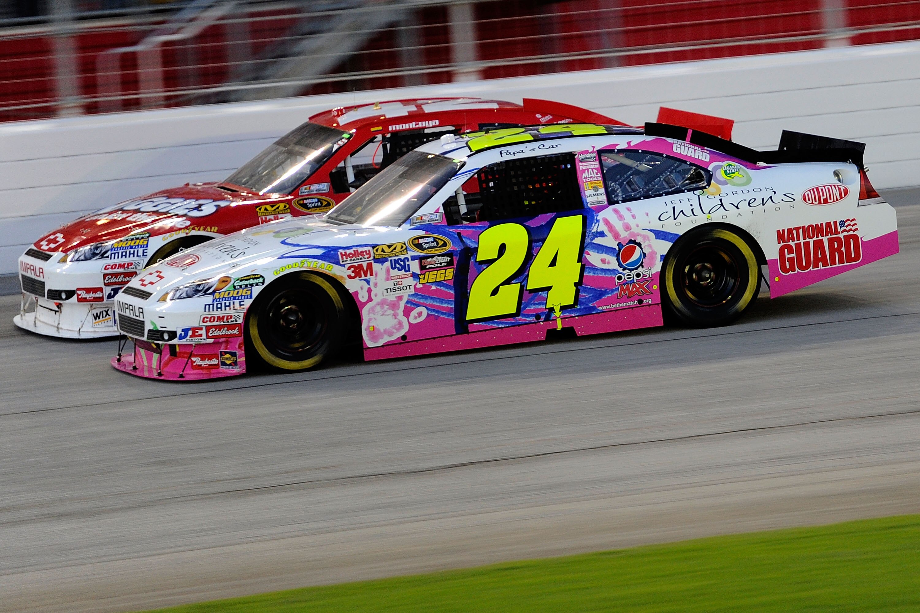 HAMPTON, GA - SEPTEMBER 05:  Jeff Gordon, driver of the #24 DuPont/Jeff Gordon Foundation Chevrolet, races Juan Pablo Montoya, driver of the #42 Huggies Chevrolet, during the NASCAR Sprint Cup Series Emory Healthcare 500 at Atlanta Motor Speedway on Septe