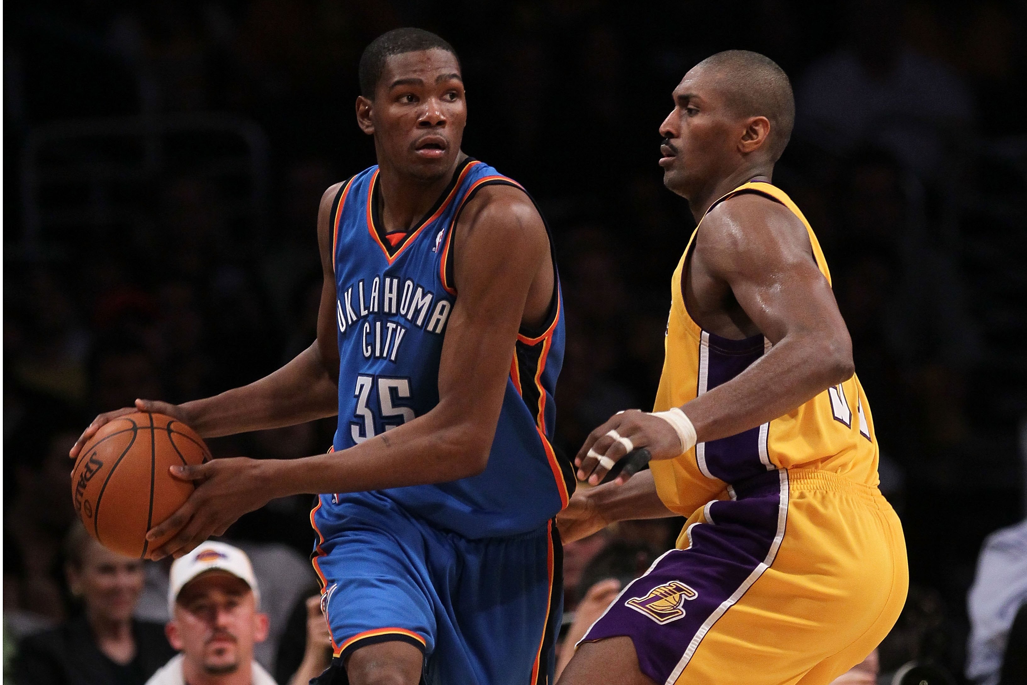 LOS ANGELES, CA - APRIL 27:  Kevin Durant #35 of the Oklahoma City Thunder looks to pass the ball as he is covered by Ron Artest #37 of the Los Angeles Lakers during Game Five of the Western Conference Quarterfinals of the 2010 NBA Playoffs at Staples Cen