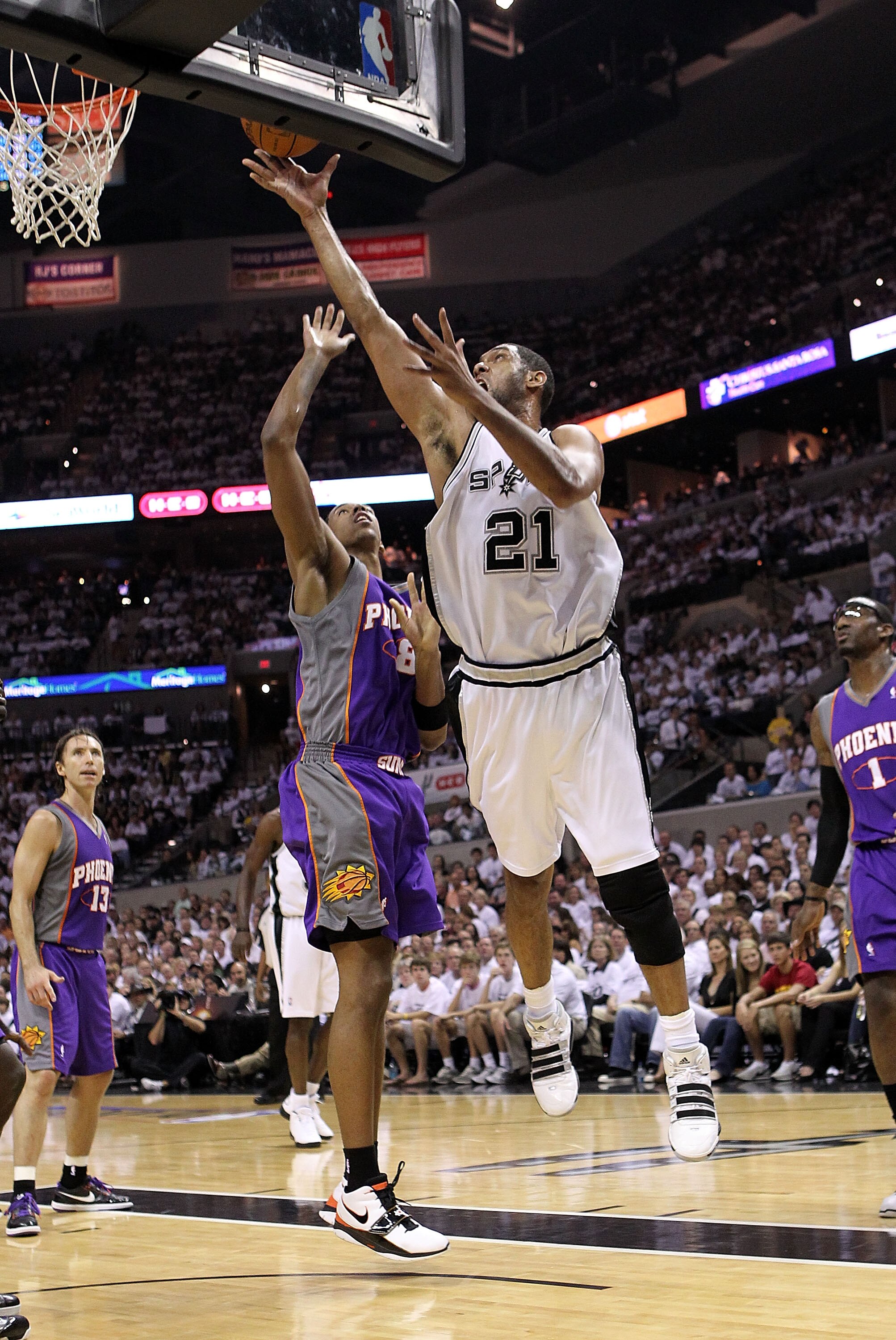 SAN ANTONIO - MAY 07:  Forward Tim Duncan #21 of the San Antonio Spurs takes  a shot against Channing Frye #8 of the Phoenix Suns in Game Three of the Western Conference Semifinals during the 2010 NBA Playoffs at AT&T Center on May 7, 2010 in San Antonio,