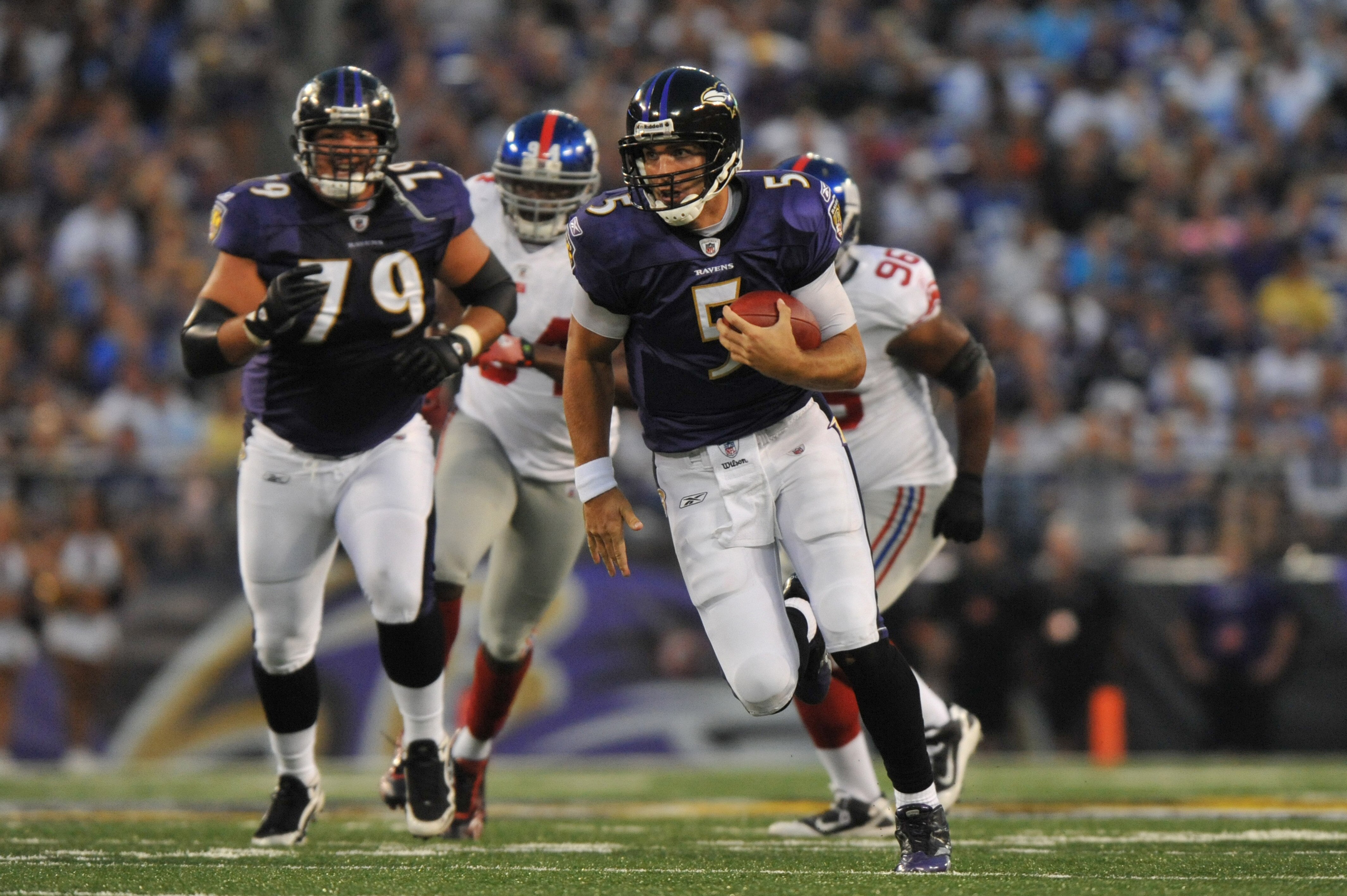 BALTIMORE - AUGUST 28:  Joe Flacco #5 of the Baltimore Ravens runs the ball against the New York Giants at M&T Bank Stadium on August 28, 2010 in Baltimore, Maryland. The Ravens lead the Giants 17-3. (Photo by Larry French/Getty Images)