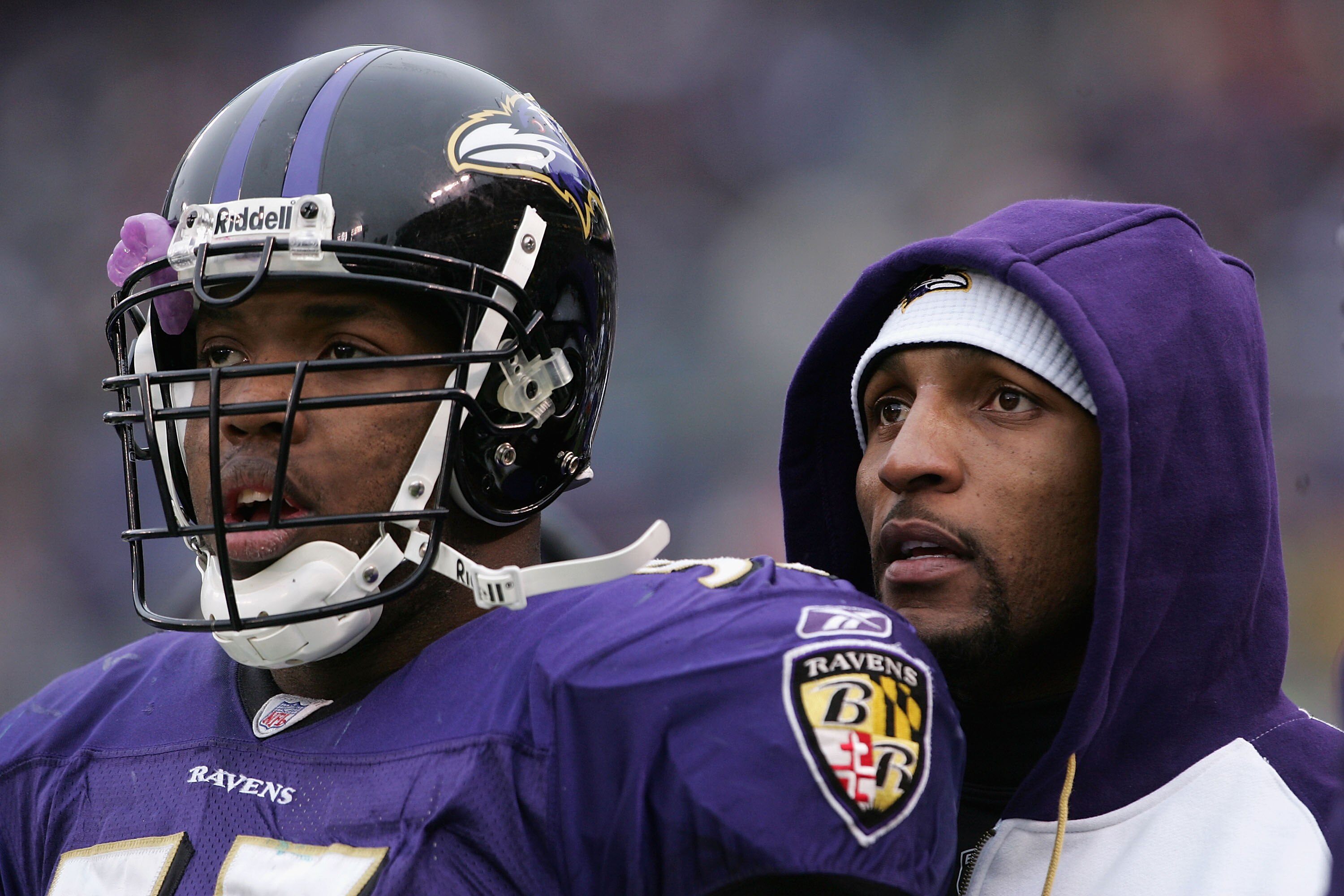 BALTIMORE - JANUARY 2:  Linebacker Terrell Suggs #55 gets words of advice from injured teammate Ray Lewis of the Baltimore Ravens watch their offense work against the Miami Dolphins as the Ravens defeated the Dolphins 30-23 during NFL action at M&T Bank S