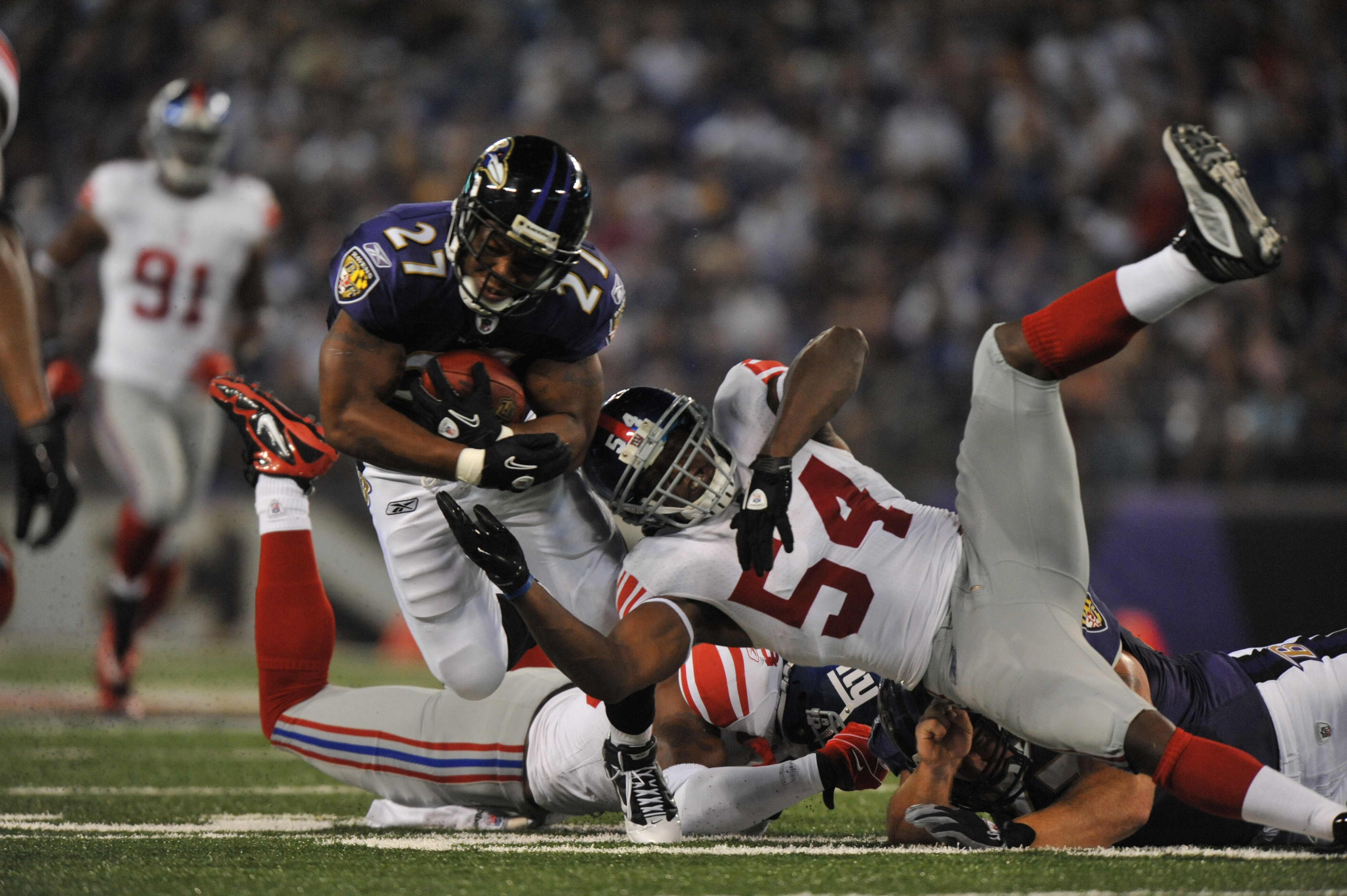 BALTIMORE - AUGUST 28:  Ray Rice #27 of the Baltimore Ravens runs the ball against Jonathan Goff #54 of the New York Giants at M&T Bank Stadium on August 28, 2010 in Baltimore, Maryland. The Ravens lead the Giants 17-3. (Photo by Larry French/Getty Images