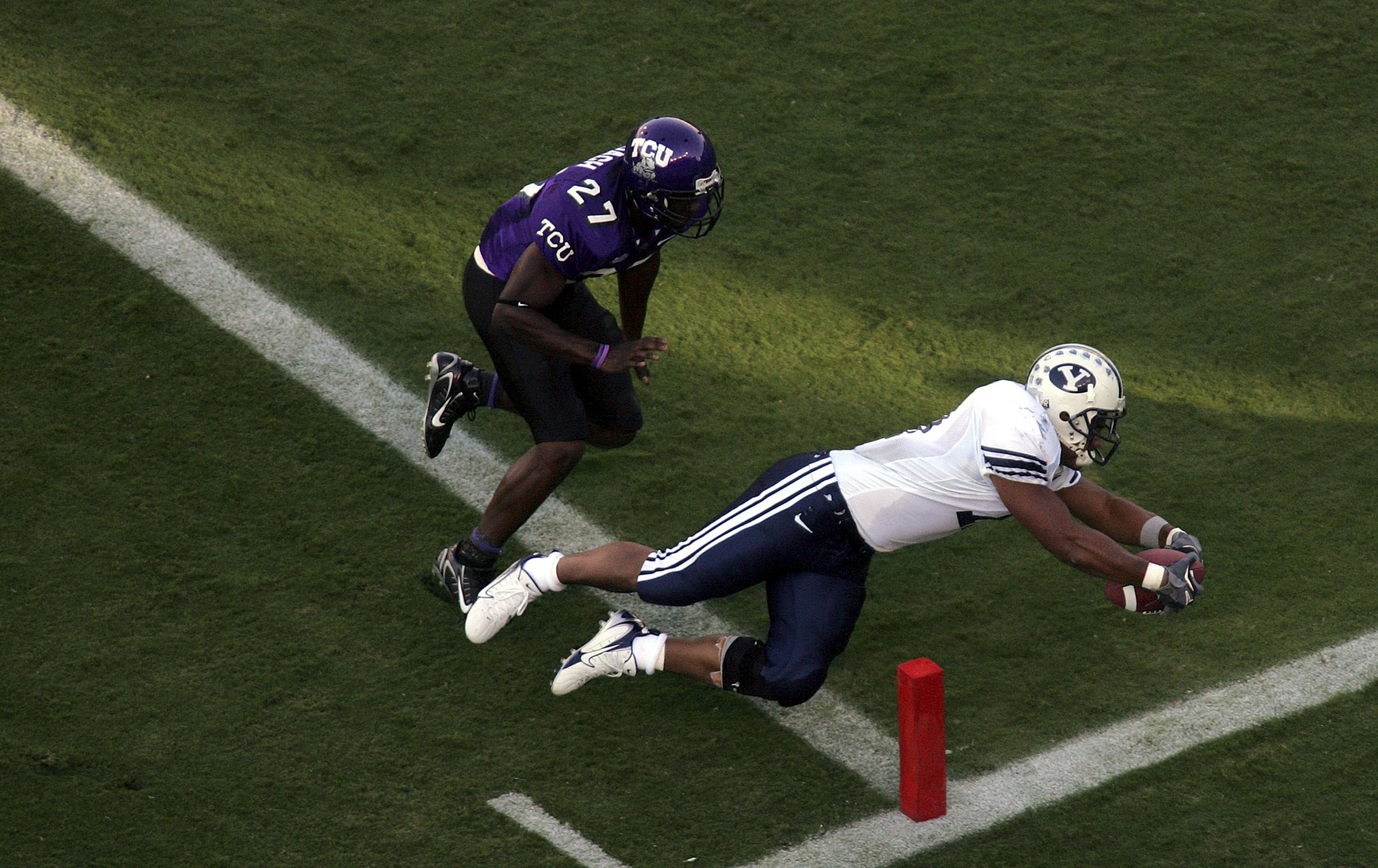 FORT WORTH, TX - SEPTEMBER 28:  Running back Manase Tonga #11 of the Brigham Young University Cougars dives into the end zone for a touchdown past David Roach #27 of the Texas Christian University Horned Frogs at Amon G. Carter Stadium on September 28, 20
