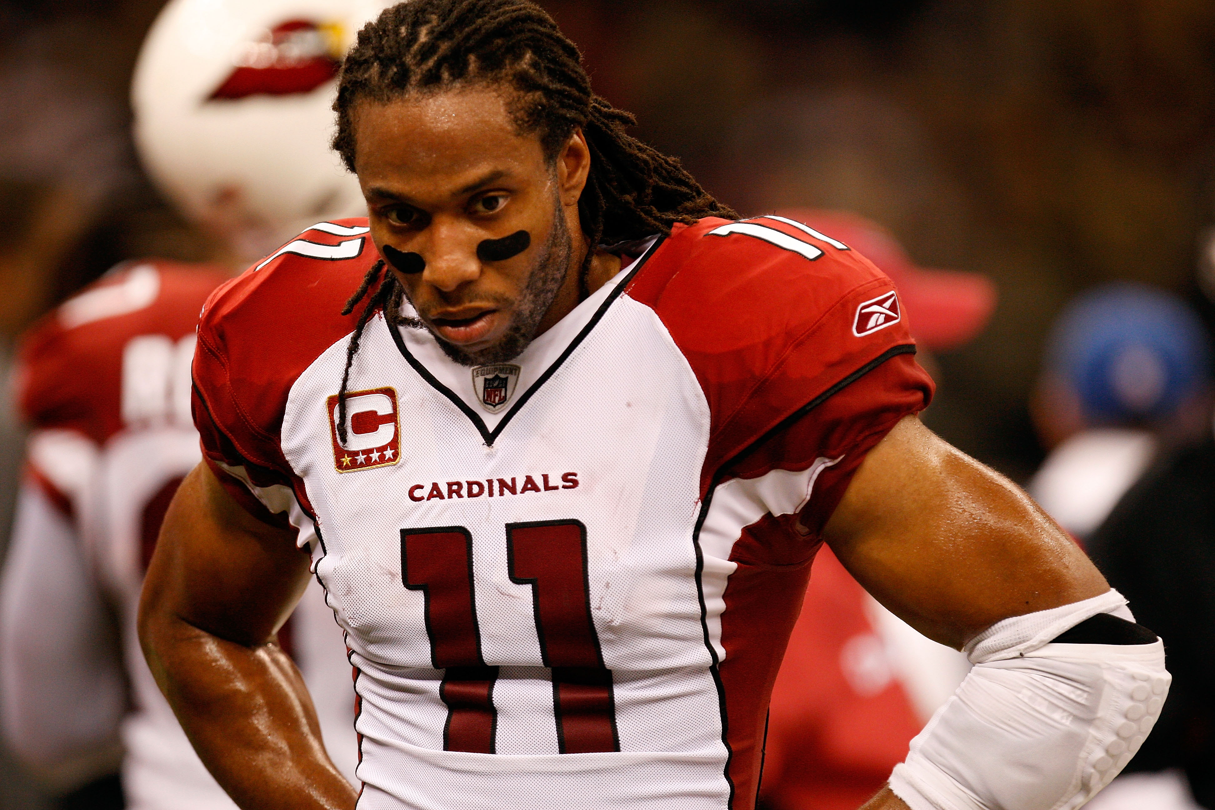 NEW ORLEANS - JANUARY 16:  Larry Fitzgerald #11  of the Arizona Cardinals stands on the sideline with his head down late in the second half against the New Orleans Saints during the NFC Divisional Playoff Game at Louisana Superdome on January 16, 2010 in