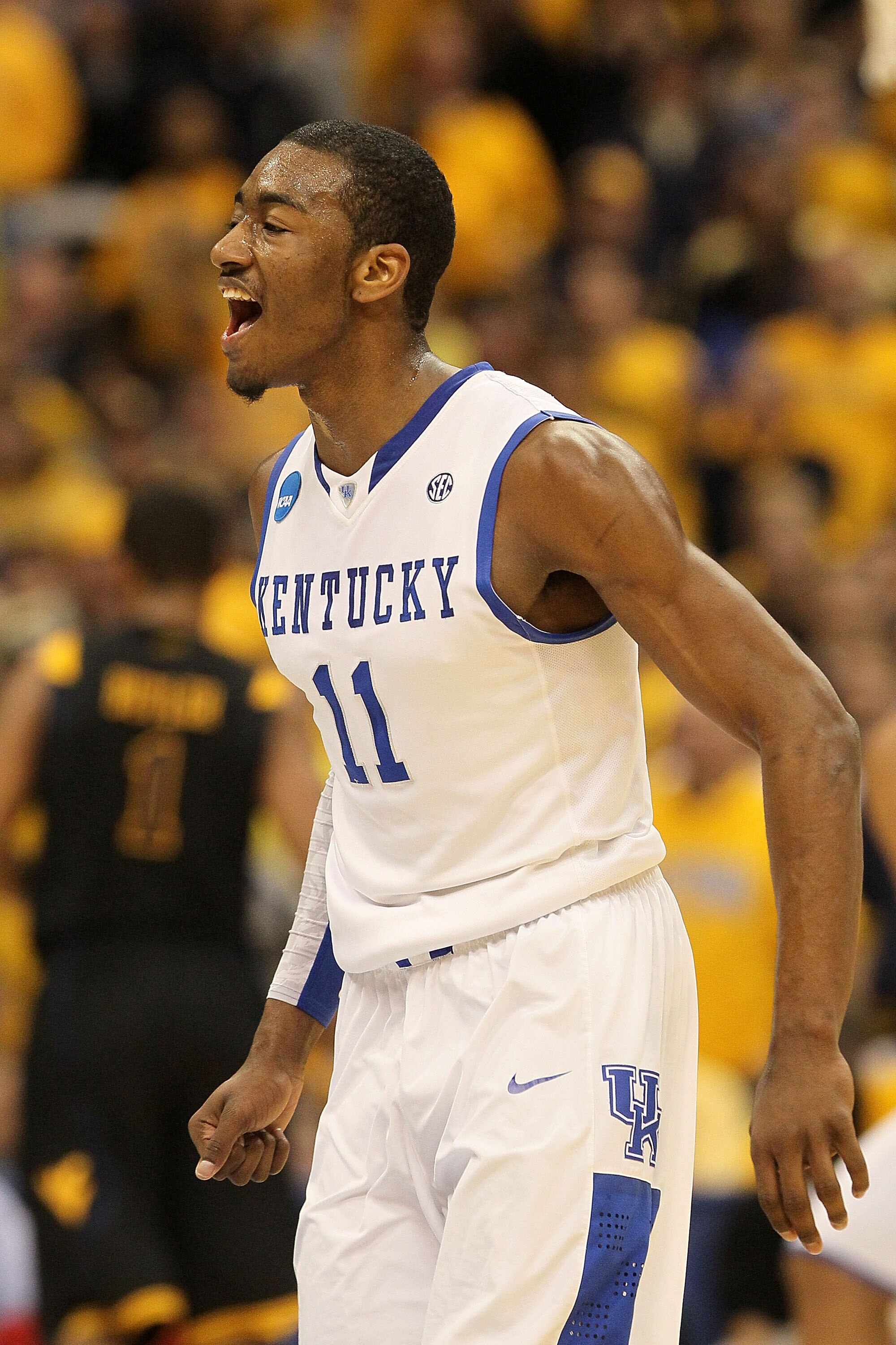 SYRACUSE, NY - MARCH 27:  John Wall #11 of the Kentucky Wildcats reacts against the West Virginia Mountaineers during the east regional final of the 2010 NCAA men's basketball tournament at the Carrier Dome on March 27, 2010 in Syracuse, New York.  (Photo