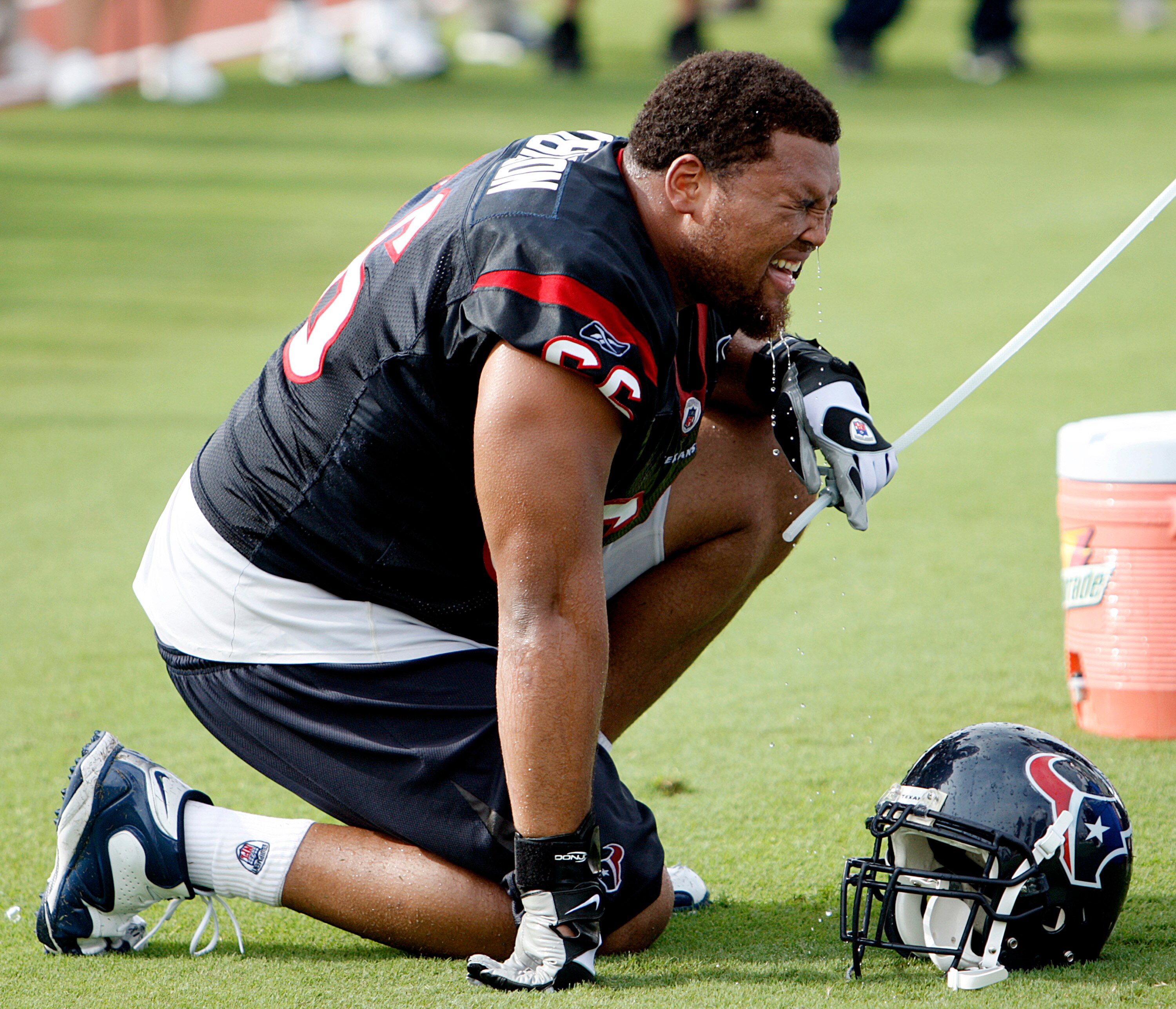 HOUSTON - JULY 31:  Defensive tackle DelJuan Robinson #66 takes a water break during practice on July 31, 2009 in Houston, Texas. Temperatures in southeast Texas once again reached at-least 100 degrees.   (Photo by Bob Levey/Getty Images)
