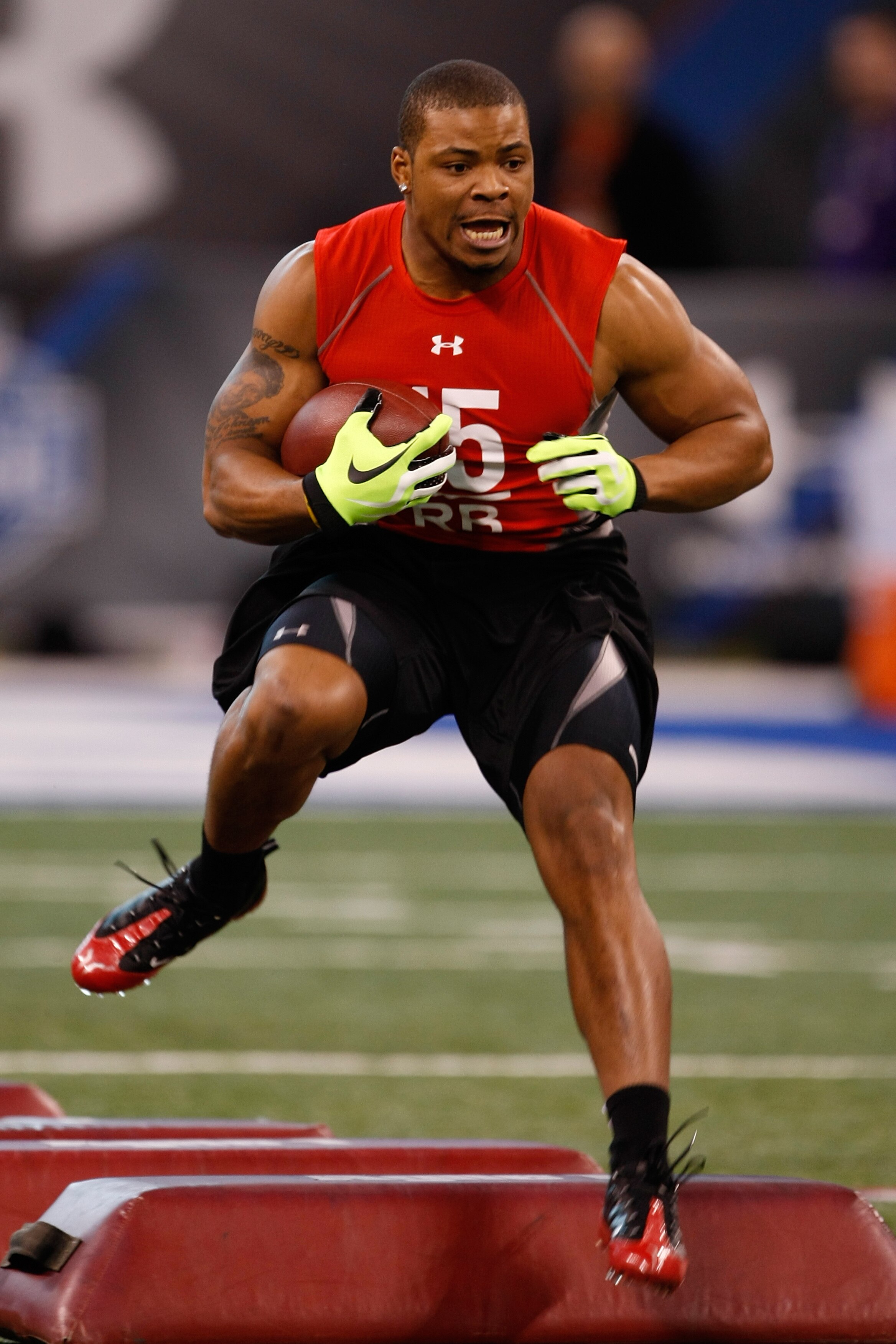 INDIANAPOLIS, IN - FEBRUARY 22:  Running back Jeremiah Johnson of Oregon runs with the football during the NFL Scouting Combine at Lucas Oil Stadium on February 22, 2009 in Indianapolis, Indiana. (Photo by Scott Boehm/Getty Images)