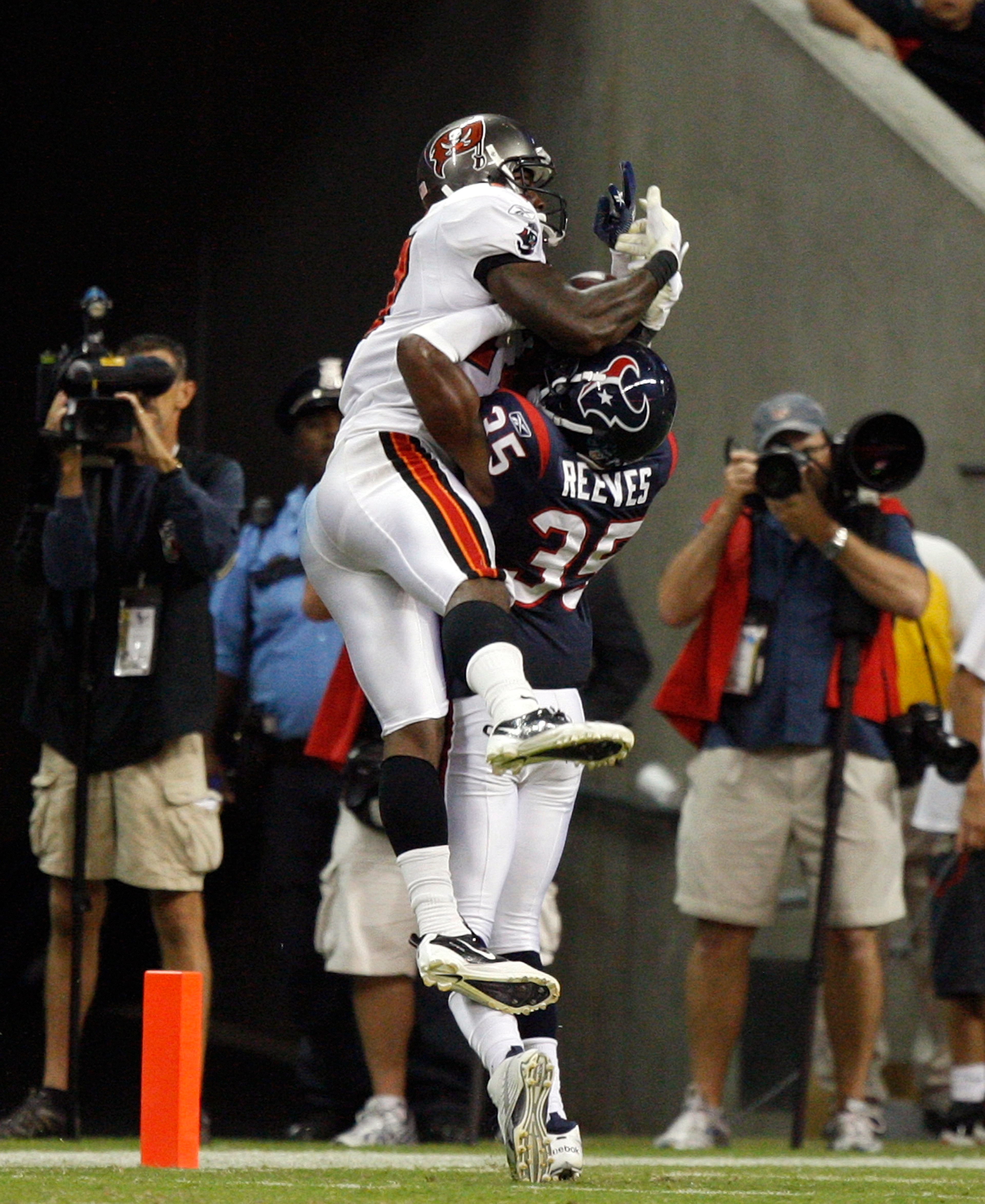 HOUSTON - SEPTEMBER 02:  Wide receiver Arrelious Benn #17 of the Tampa Bay Buccaneers leaps over cornerback Jacques Reeves #35 of the Houston Texans for a touchdown in the fourth quarter at Reliant Stadium on September 2, 2010 in Houston, Texas.  (Photo b