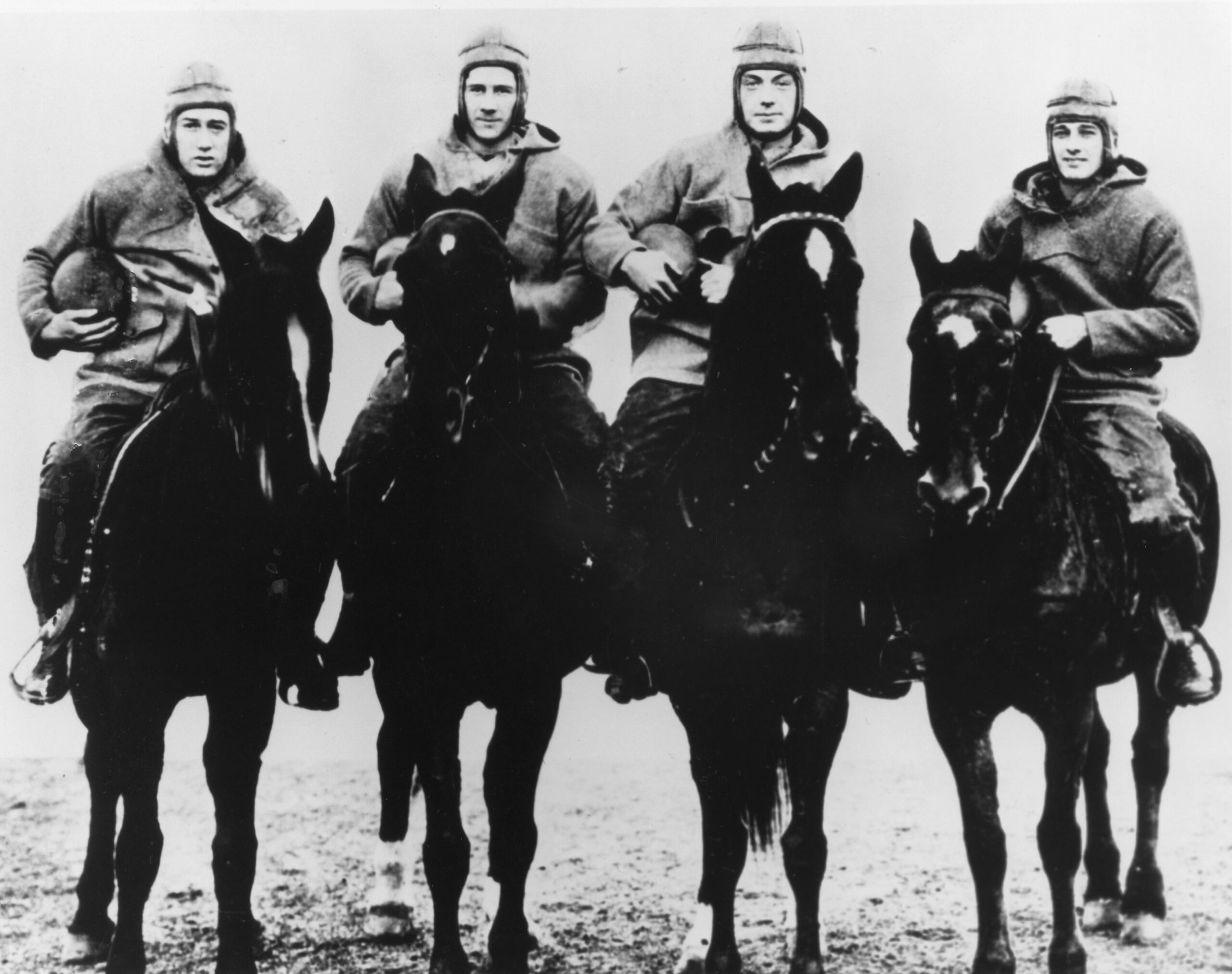 The Four Horsemen of Notre Dame, (L-R) quarterback Harry Stuhldreher, fullback Elmer Leyden, left halfback Jim Crowley, and right hafback Don Miller. George Strickler, Knute Rockne's student publicity aide posed the four players, dressed in their uniforms The Four Horsemen of Notre Dame, (L-R) quarterback Harry Stuhldreher, fullback Elmer Leyden, left halfback Jim Crowley, and right hafback Don Miller. George Strickler, Knute Rockne's student publicity aide posed the four players, dressed in their uniforms