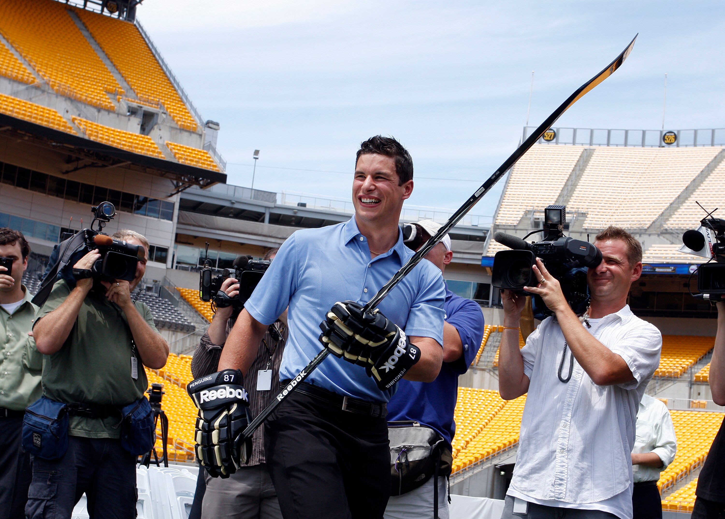 PITTSBURGH - JULY 27:  Sidney Crosby of the Pittsburgh Penguins laughs during a shooting competition at the 2011 Bridgestone NHL Winter Classic press conference on July 27, 2010 at Heinz Field in Pittsburgh, Pennsylvania.  (Photo by Justin K. Aller/Getty