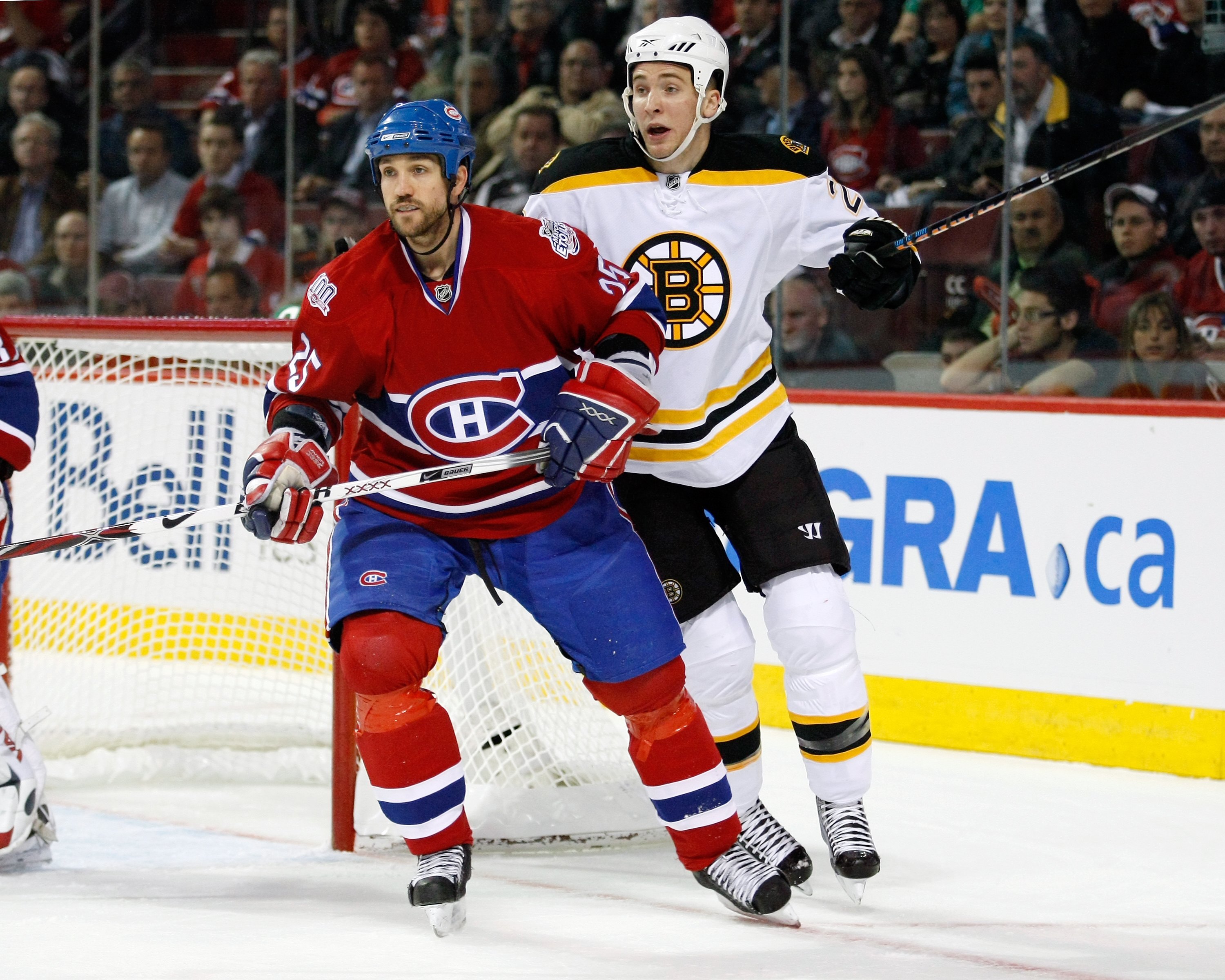 MONTREAL- APRIL 20:  Mathieu Dandenault #25 of the Montreal Canadiens defends against Blake Wheeler #26 of the Boston Bruins during Game Three of the Eastern Conference Quarterfinals of the 2009 Stanley Cup Playoffs at the Bell Centre on April 20, 2009 in