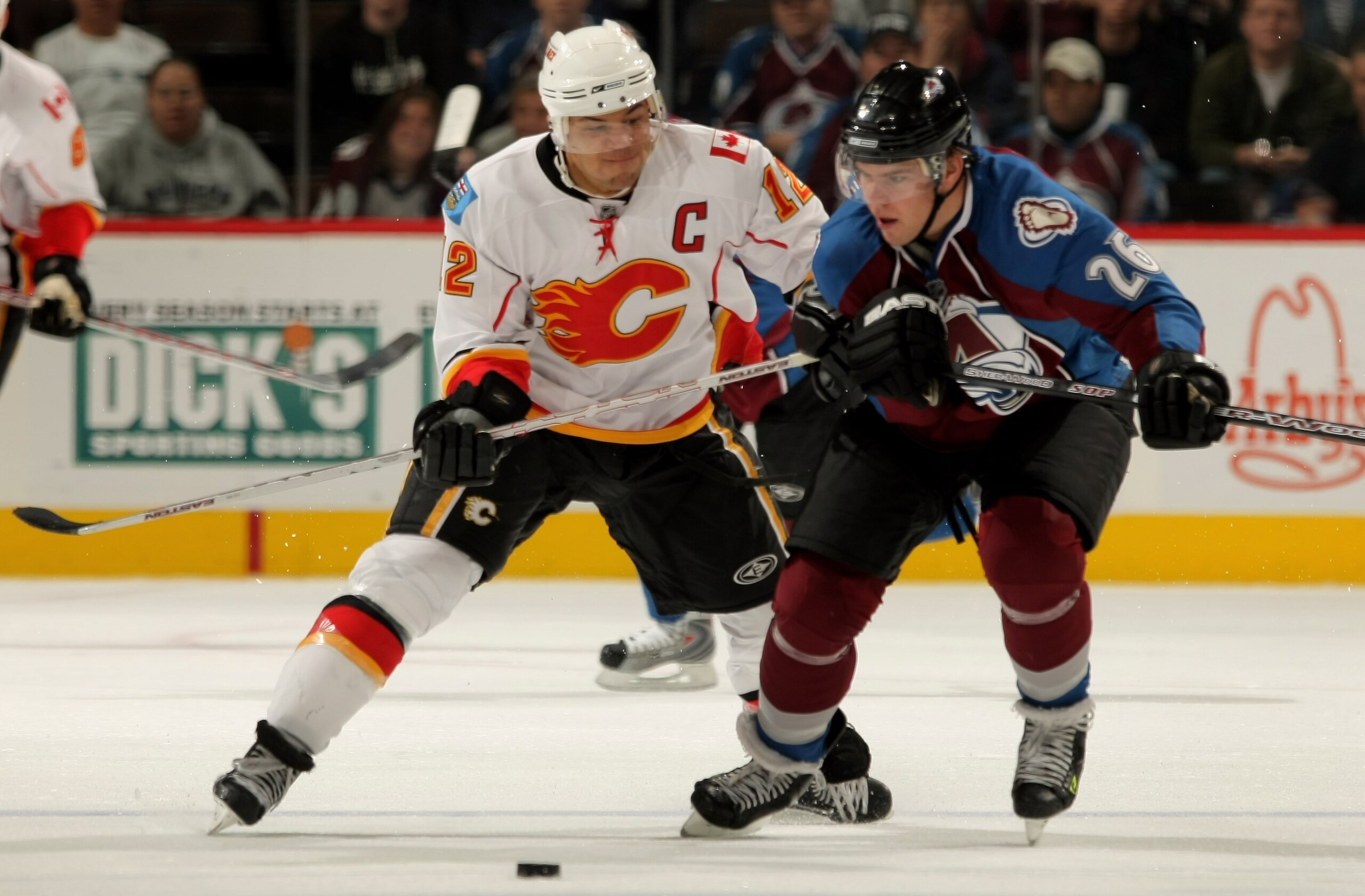 DENVER - OCTOBER 16:  Paul Stastny #26 of the Colorado Avalanche and Jarome Iginla #12 of the Calgary Flames pursue the puck during NHL action at the Pepsi Center on October 16, 2007.  (Photo by Doug Pensinger/Getty Images)