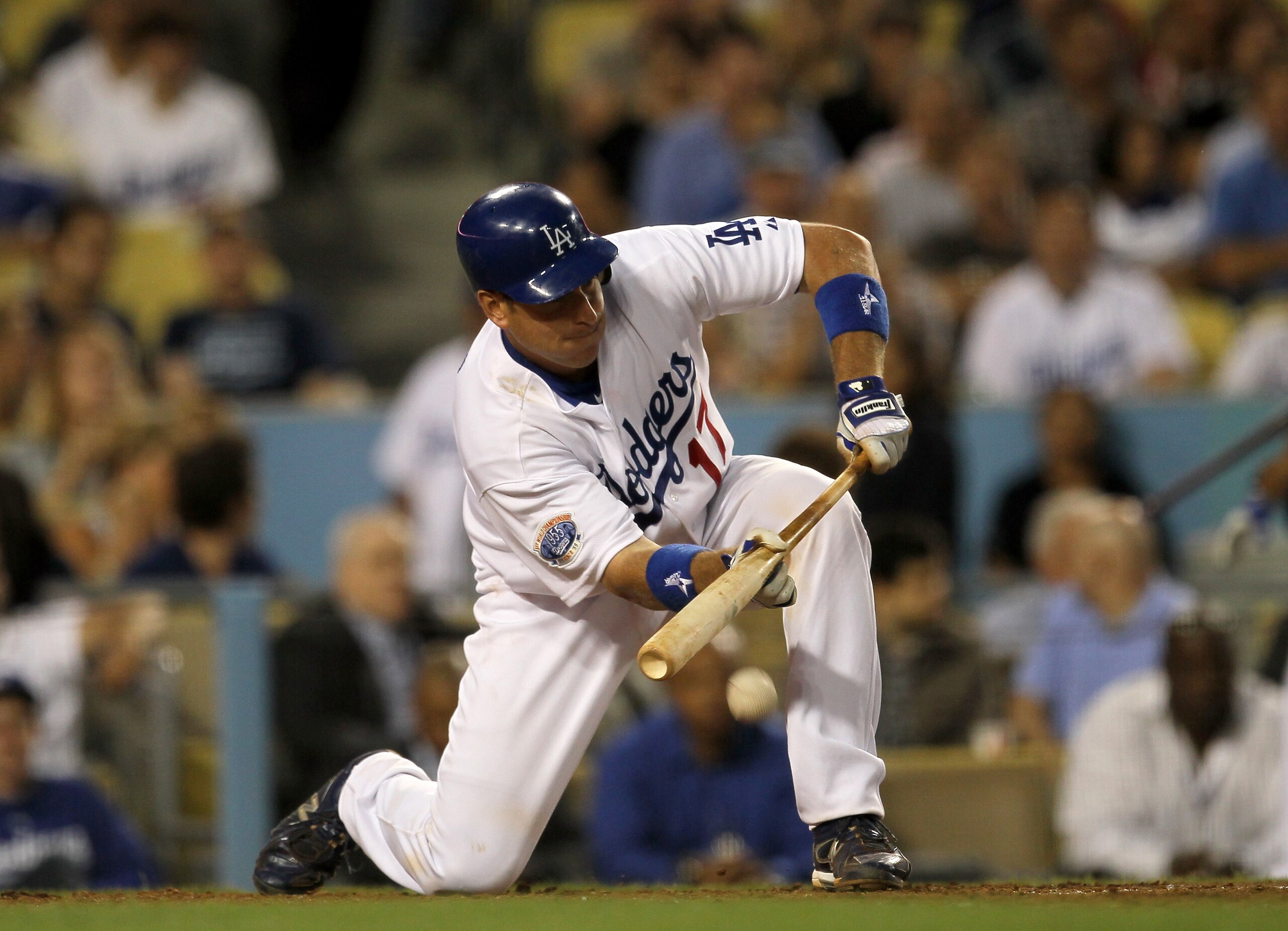 LOS ANGELES - JUNE 7:  A.J. Ellis #17 of the Los Angeles Dodgers lays down an RBI bunt to score Ronnie Belliard from third base in the fourth inning against the St. Louis Cardinals on June 7, 2010 at Dodger Stadium in Los Angeles, California.   (Photo by