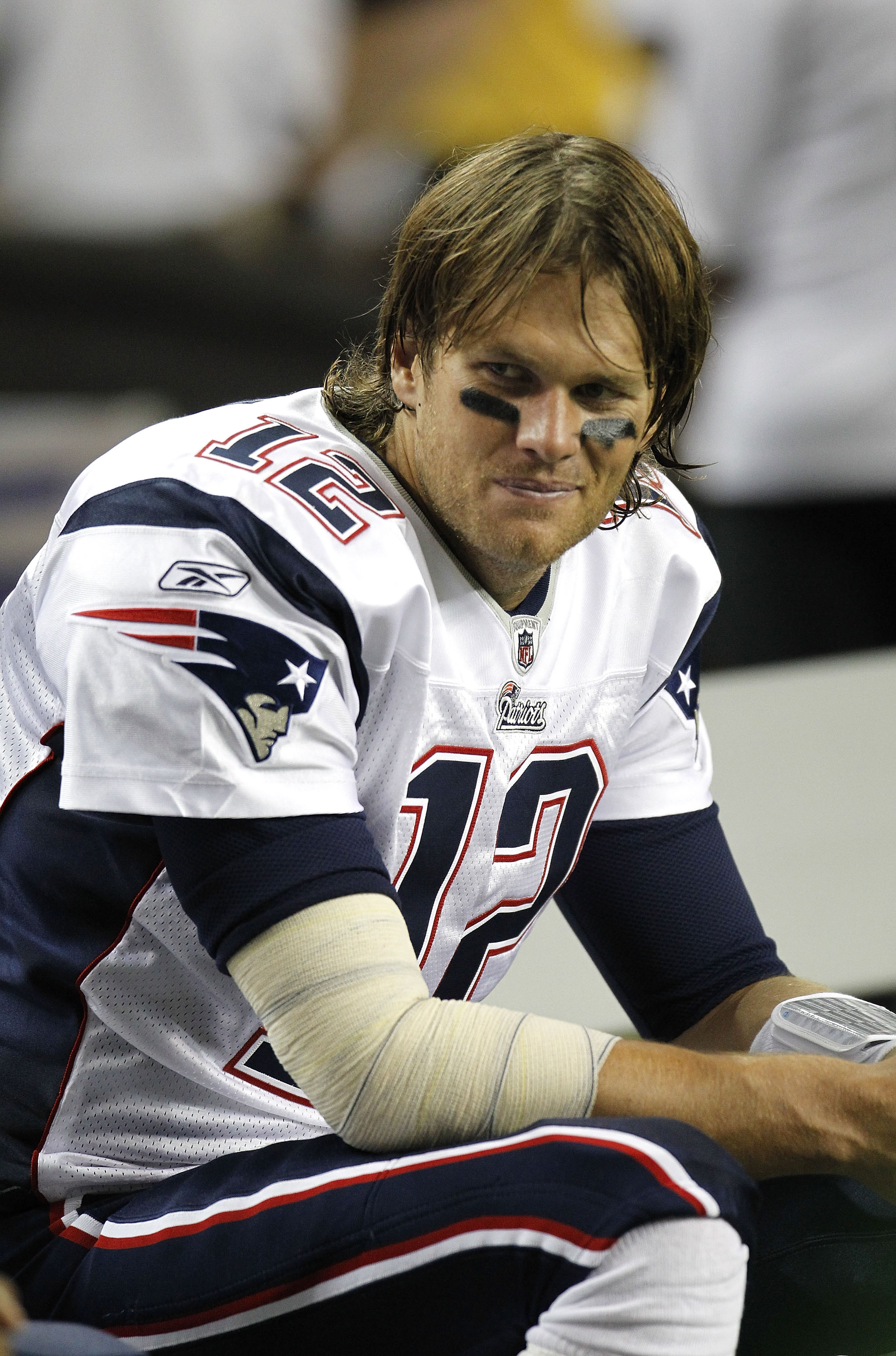 ATLANTA - AUGUST 19:  Quarterback Tom Brady #12 of the New England Patriots sits on the bench during the preseason game against the Atlanta Falcons at the Georgia Dome on August 19, 2010 in Atlanta, Georgia.  The Patriots beat the Falcons 28-10.  (Photo b