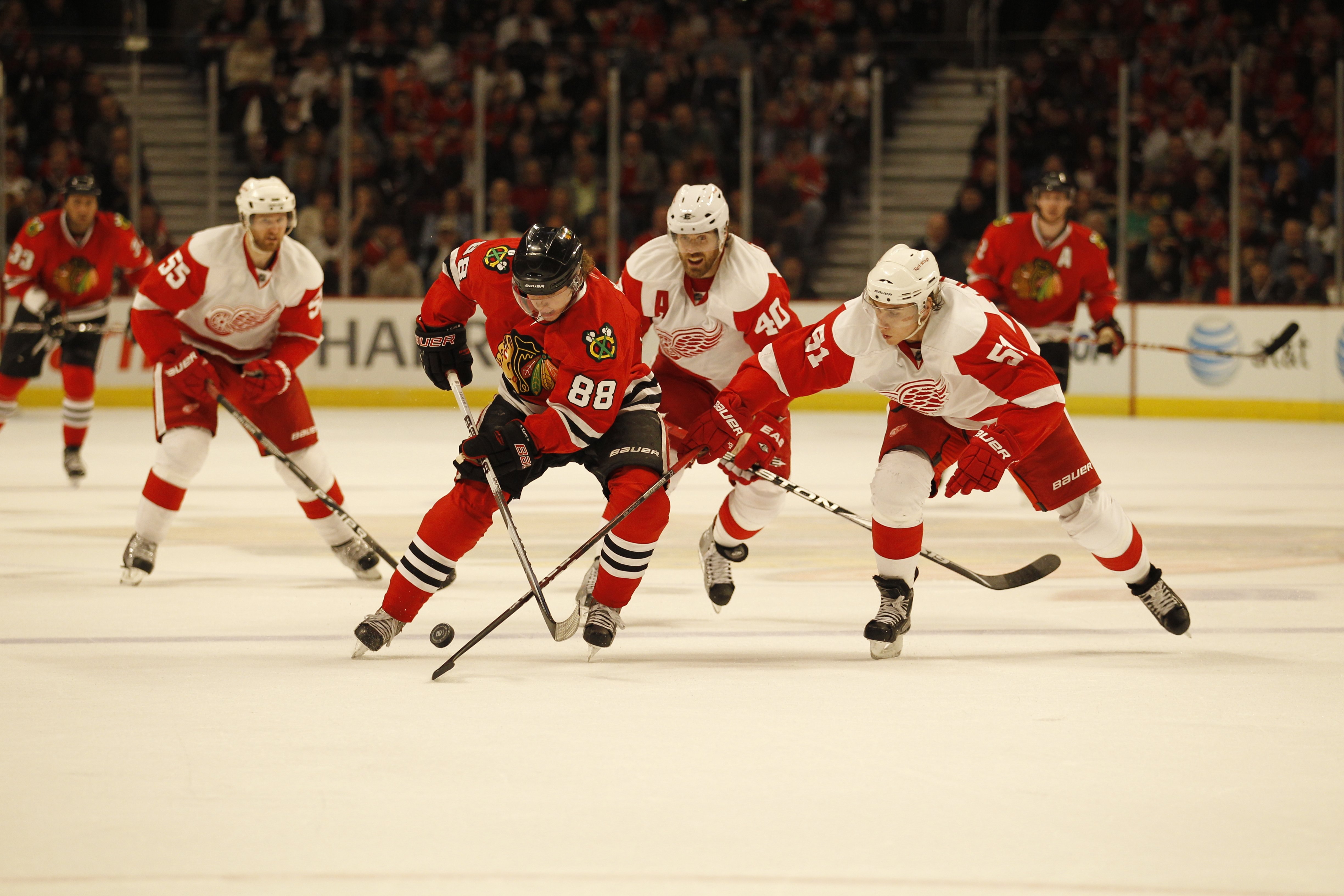 CHICAGO - APRIL 11: Patrick Kane #88 of the Chicago Blackhawks skates past Valtteri Filppula #51 and Henrik Zetterberg #40 of the Detroit Red Wings at the United Center on April 11, 2010 in Chicago, Illinois. The Red Wings defeated the Blackhawks 3-2 in o