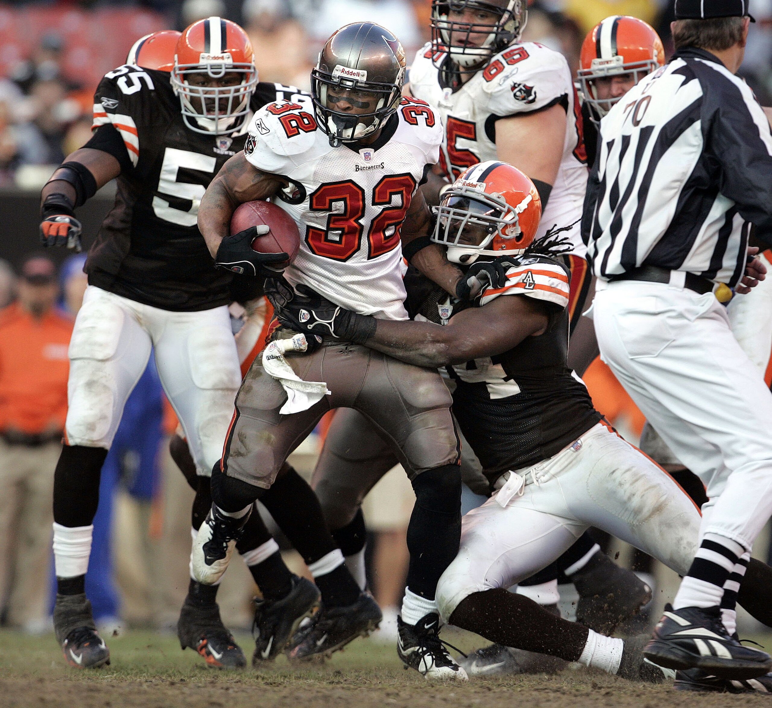 CLEVELAND, OH - DECEMBER 24:  Michael Pittman #32 of the Tampa Bay Buccaneers is tackled by Leon Williams #94 of the Cleveland Browns during the fourth quarter on December 24, 2006 at Cleveland Browns Stadium in Cleveland, Ohio.  Tampa Bay defeated Clevel