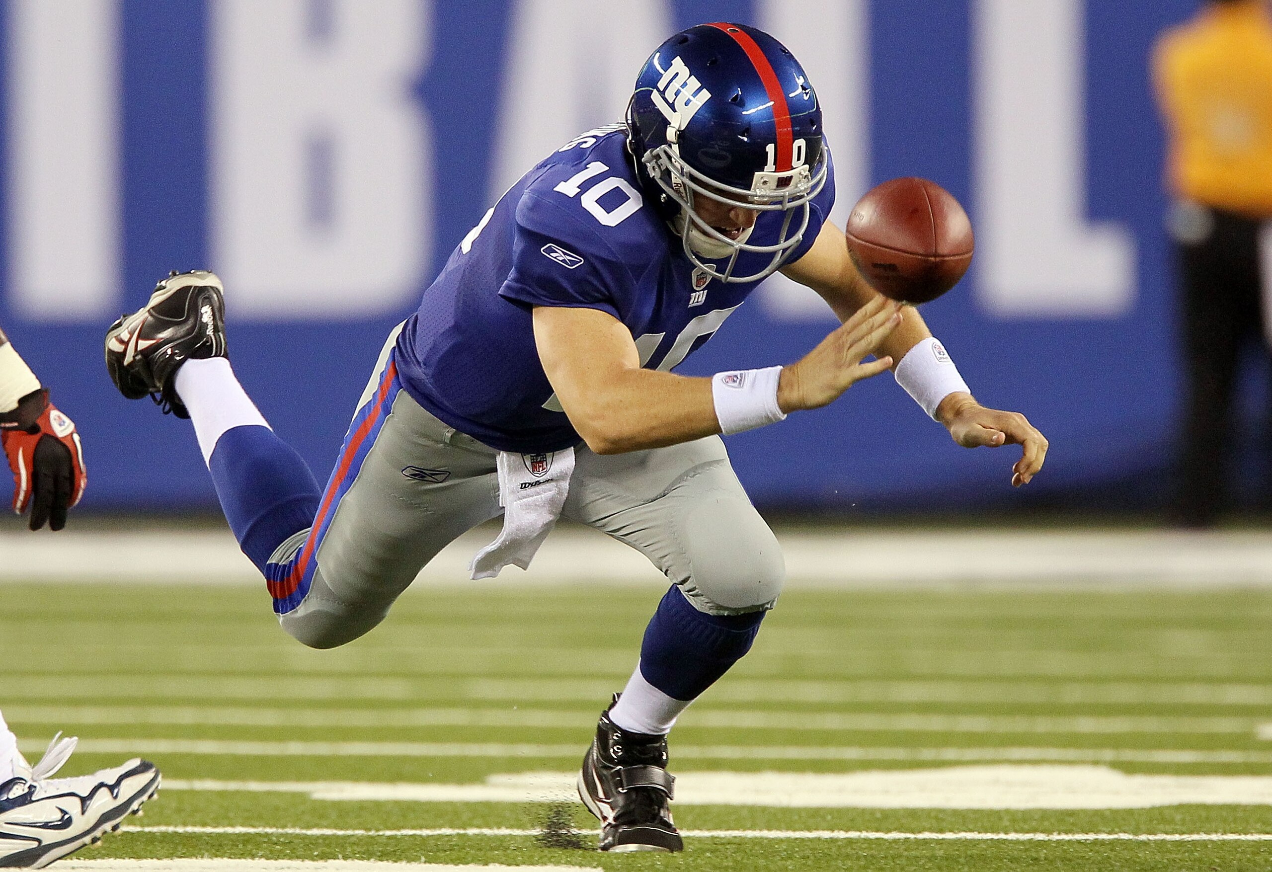 EAST RUTHERFORD, NJ - SEPTEMBER 02:  Eli Manning #10 of the New York Giants fumbles the ball in the first quarter against the New England Patriots on September 2, 2010 at the New Meadowlands Stadium in East Rutherford, New Jersey.  (Photo by Jim McIsaac/G