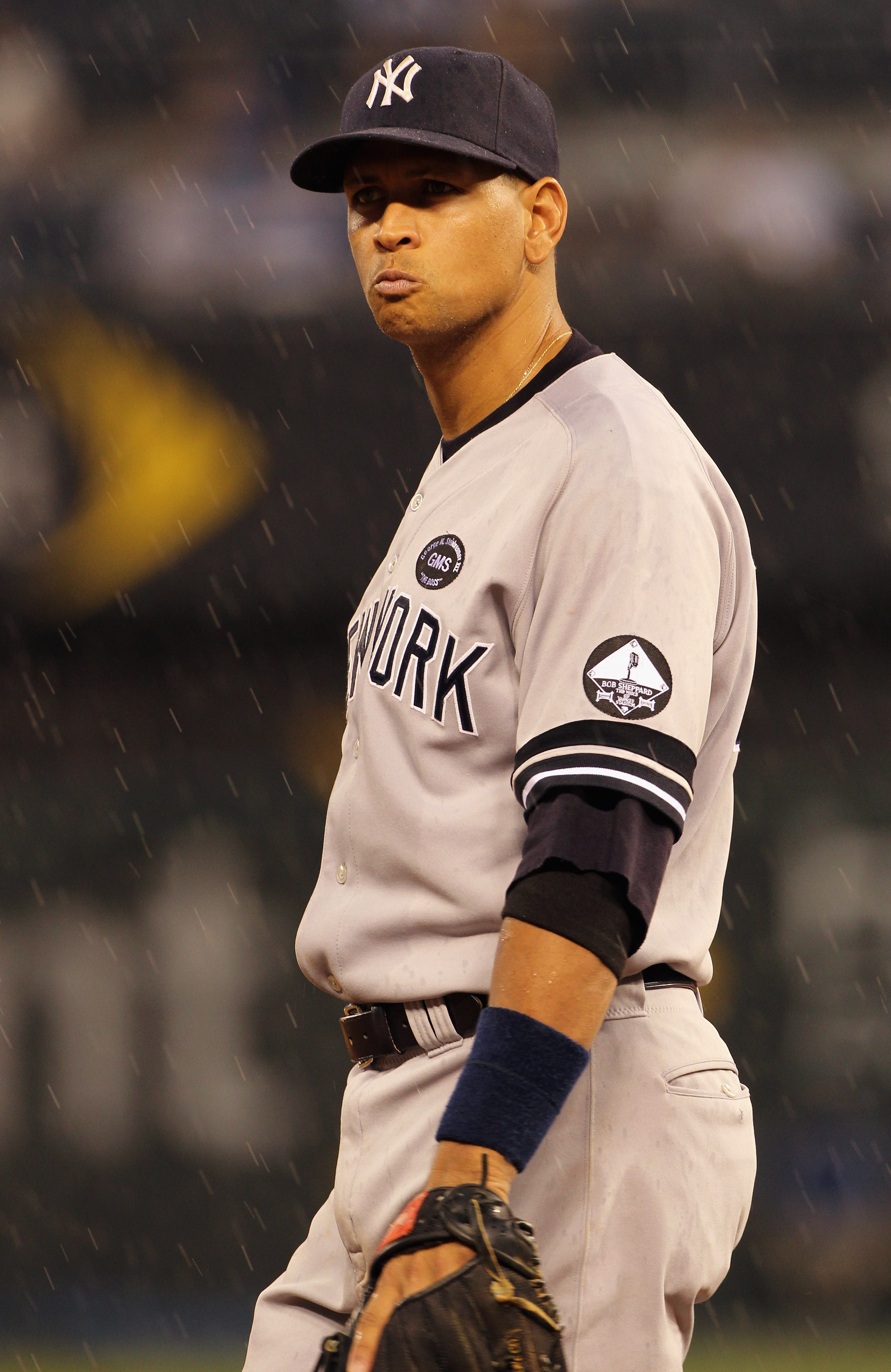 KANSAS CITY, MO - AUGUST 13:  Alex Rodriguez #13 of the New York Yankees looks on as it begins to rain during the game against the Kansas City Royals on August 13, 2010 at Kauffman Stadium in Kansas City, Missouri.  (Photo by Jamie Squire/Getty Images)